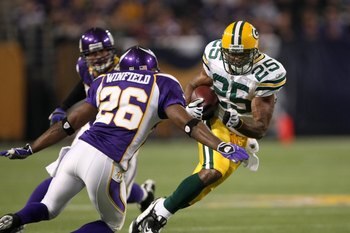 MINNEAPOLIS - NOVEMBER 09:  Running back Ryan Grant #25 of the Green Bay Packers carries the ball against cornerback Antoine Winfield #26 of the Minnesota Vikings on November 9, 2008 at the Metrodome in Mineapolis, Minnesota.  The Vikings won 28-27.  (Pho