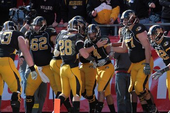 KANSAS CITY, MO - NOVEMBER 27:  Kendial Lawrence #4 of the Missouri Tigers is congratulated after scoring a touchdown during the game against the Kansas Jayhawks on November 27, 2010 at Arrowhead Stadium in Kansas City, Missouri.  (Photo by Jamie Squire/G
