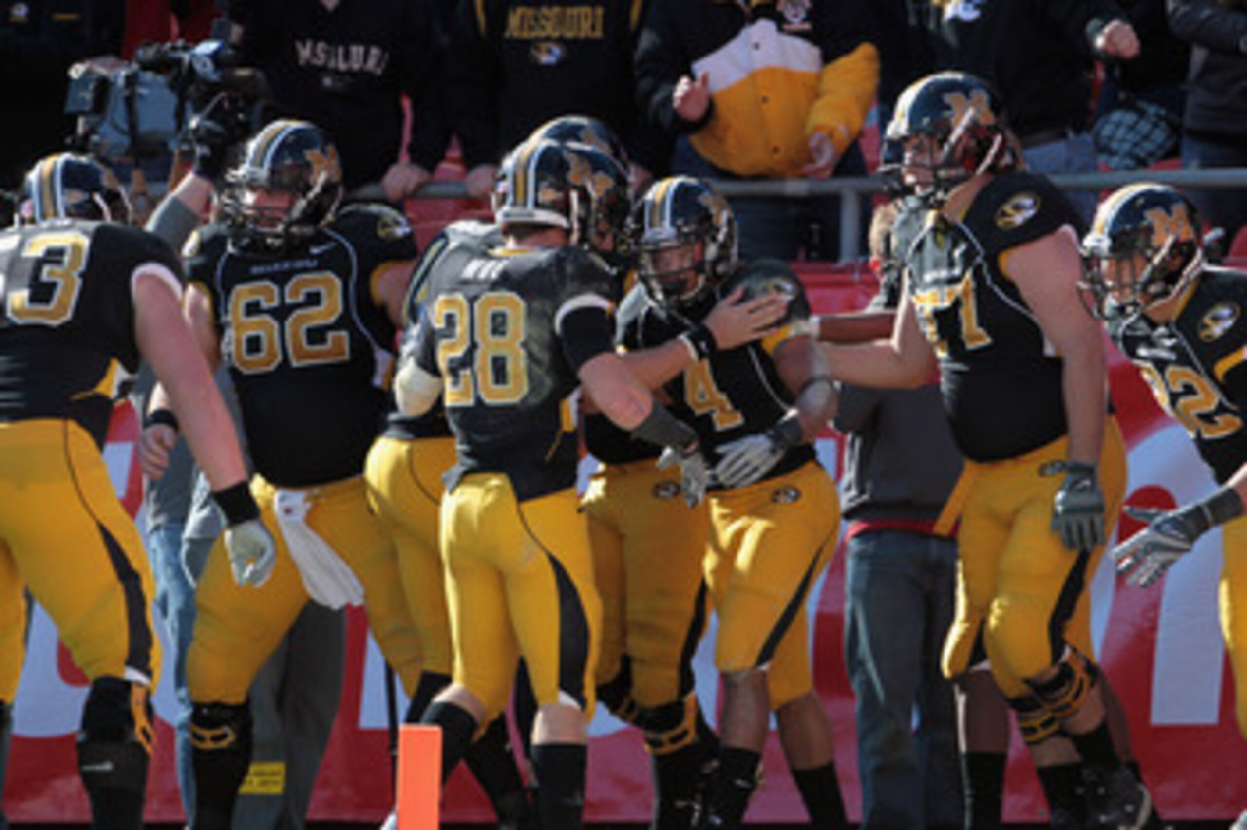 KANSAS CITY, MO - NOVEMBER 27:  Kendial Lawrence #4 of the Missouri Tigers is congratulated after scoring a touchdown during the game against the Kansas Jayhawks on November 27, 2010 at Arrowhead Stadium in Kansas City, Missouri.  (Photo by Jamie Squire/G