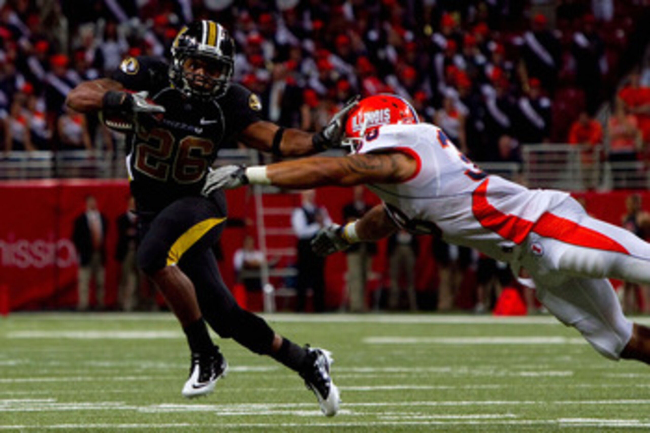 ST. LOUIS - SEPTEMBER 4: De'Vion Moore #26 of the University of Missouri Tigers looks to get past Ian Thomas #38 of the University of Illinois Fighting Illini during the State Farm Arch Rivalry game on September 4, 2010 at the Edward Jones Dome in St. Lou