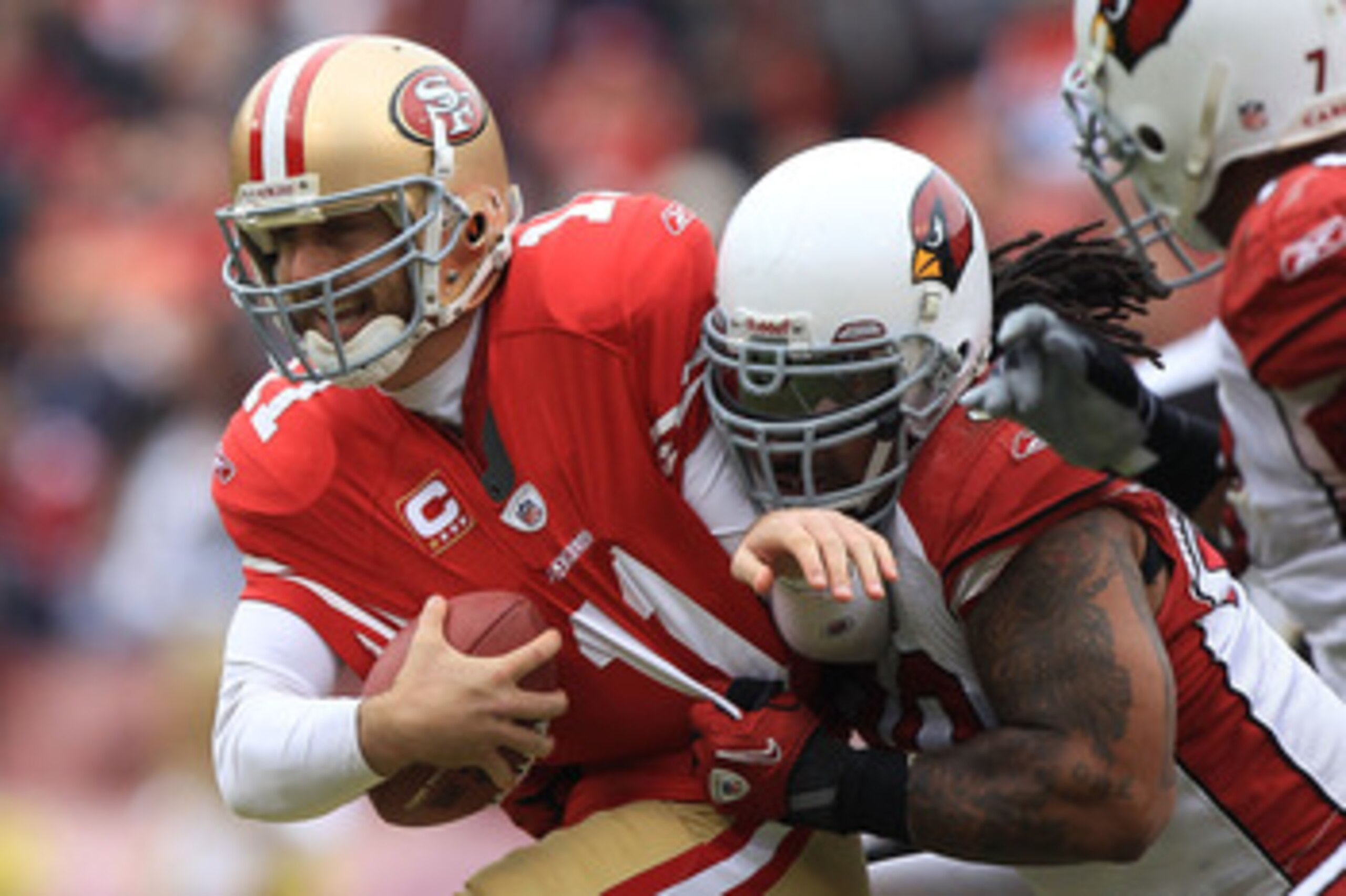 SAN FRANCISCO, CA - JANUARY 02:    Alex Smith #11 of the San Francisco 49ers is sacked by Darnell Dockett #90 of the Arizona Cardinals during an NFL game at Candlestick Park on January 2, 2011 in San Francisco, California.  (Photo by Jed Jacobsohn/Getty I
