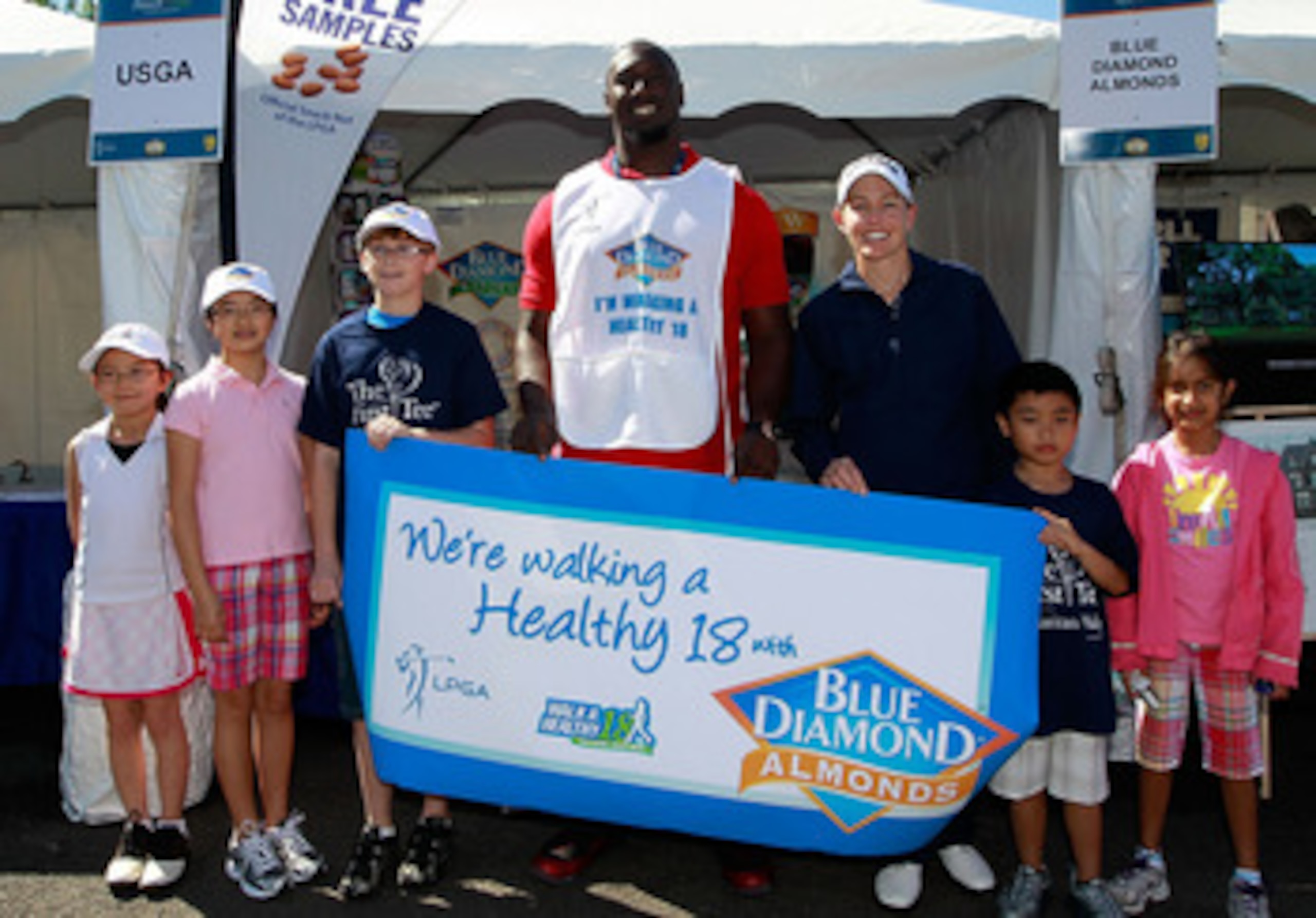 GLADSTONE, NJ - MAY 21: NFL player Muhammad Wilkerson of the New York Jets joins LPGA player Stephanie Louden and local junior golfers to support Blue Diamond Almonds 'Walk A Healthy 18' program at the Sybase Match Play Championship at Hamilton Farm Golf 