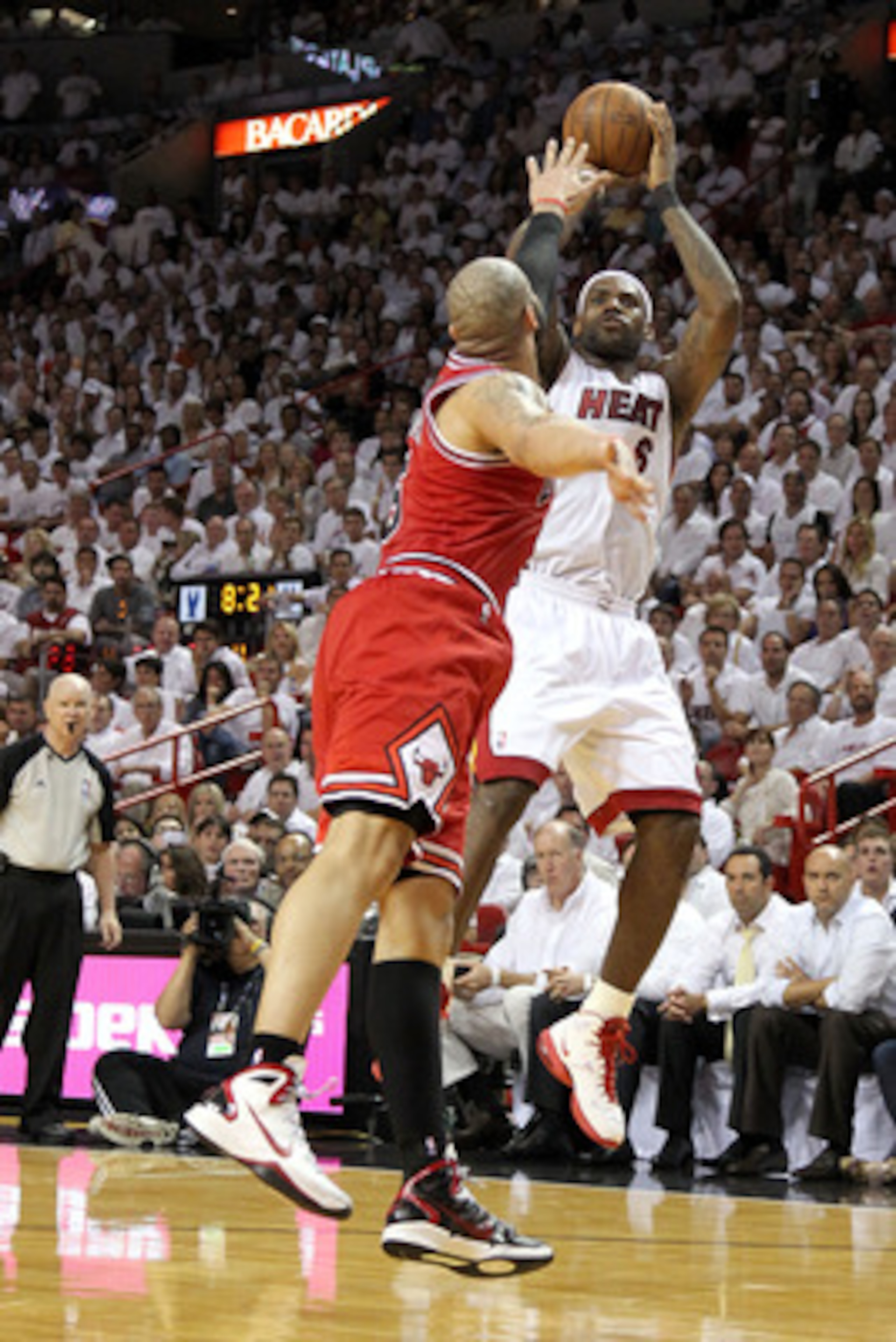 MIAMI, FL - MAY 24: LeBron James #6 of the Miami Heat attempts a shot as Carlos Boozer #5 of the Chicago Bulls puts his hand over his face in Game Four of the Eastern Conference Finals during the 2011 NBA Playoffs on May 24, 2011 at American Airlines Are MIAMI, FL - MAY 24: LeBron James #6 of the Miami Heat attempts a shot as Carlos Boozer #5 of the Chicago Bulls puts his hand over his face in Game Four of the Eastern Conference Finals during the 2011 NBA Playoffs on May 24, 2011 at American Airlines Are