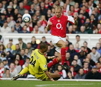 LONDON - OCTOBER 2:  Dennis Bergkamp of Arsenal evades Jonathan Fortune of Charlton Athletic during the Barclays Premiership match between Arsenal and Charlton Atheltic at Highbury on October 2, 2004 in London. (Photo by Shaun Botterill/Getty Images)