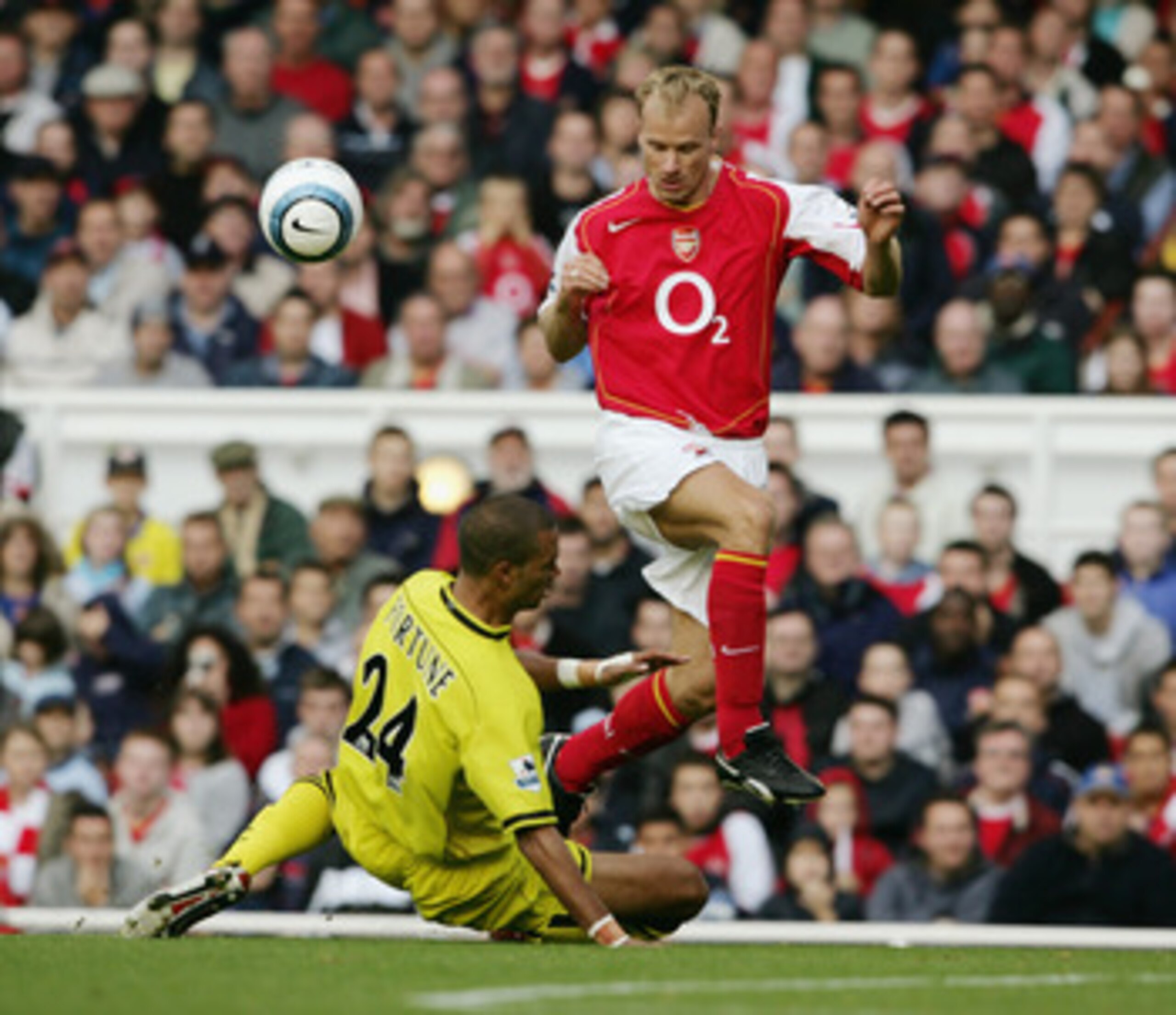 LONDON - OCTOBER 2: Dennis Bergkamp of Arsenal evades Jonathan Fortune of Charlton Athletic during the Barclays Premiership match between Arsenal and Charlton Atheltic at Highbury on October 2, 2004 in London. (Photo by Shaun Botterill/Getty Images) LONDON - OCTOBER 2: Dennis Bergkamp of Arsenal evades Jonathan Fortune of Charlton Athletic during the Barclays Premiership match between Arsenal and Charlton Atheltic at Highbury on October 2, 2004 in London. (Photo by Shaun Botterill/Getty Images)