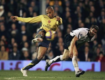 LONDON - NOVEMBER 29:Thiery Henry of Arsenal has a shot on goal while Moriz Voltz of Fulham looks on during the Barclays Premiership match between Fulham and  Arsenal at Craven Cottage on November 29, 2006 in London, England. (Photo by Phil Cole/Getty Ima