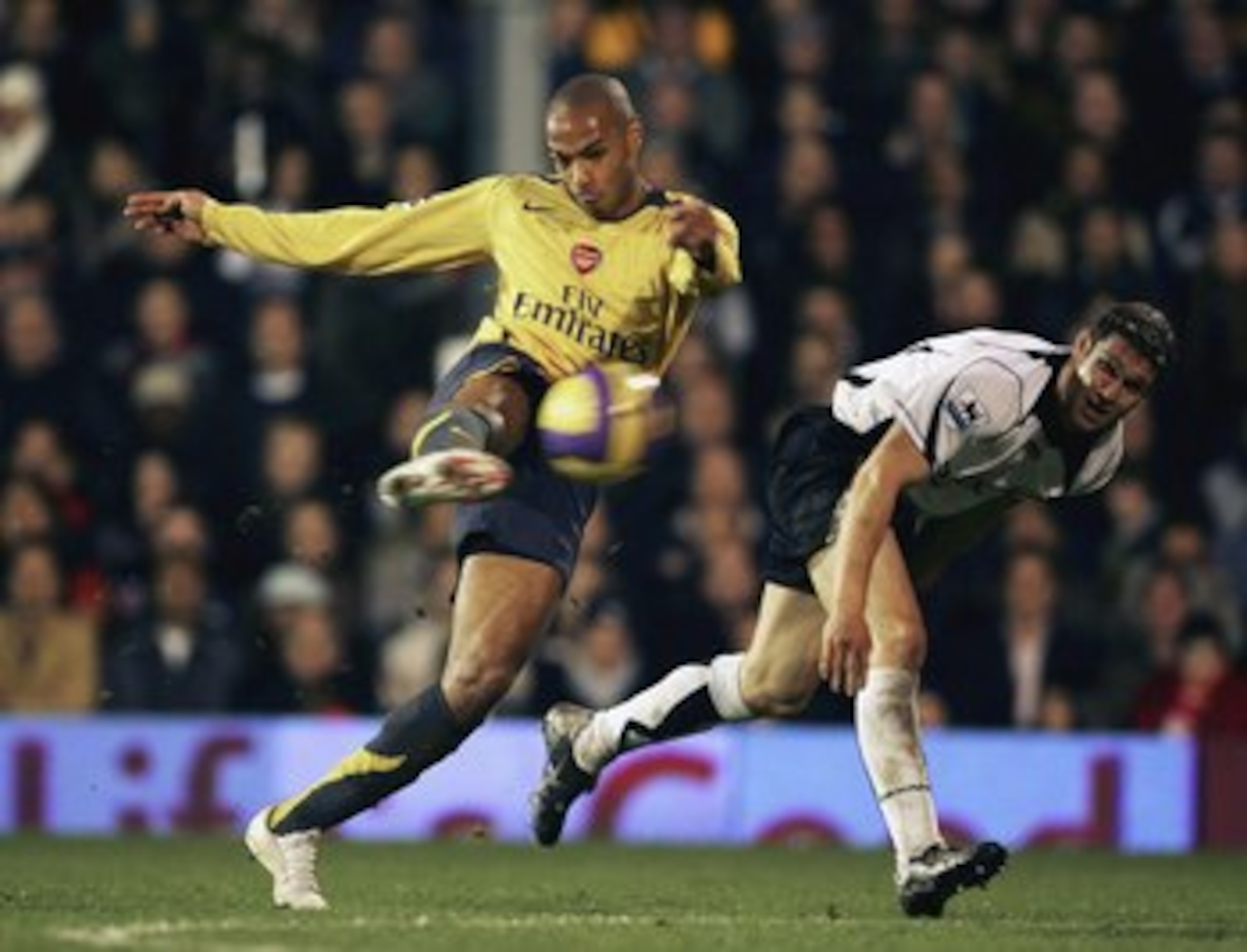 LONDON - NOVEMBER 29:Thiery Henry of Arsenal has a shot on goal while Moriz Voltz of Fulham looks on during the Barclays Premiership match between Fulham and Arsenal at Craven Cottage on November 29, 2006 in London, England. (Photo by Phil Cole/Getty Ima LONDON - NOVEMBER 29:Thiery Henry of Arsenal has a shot on goal while Moriz Voltz of Fulham looks on during the Barclays Premiership match between Fulham and Arsenal at Craven Cottage on November 29, 2006 in London, England. (Photo by Phil Cole/Getty Ima