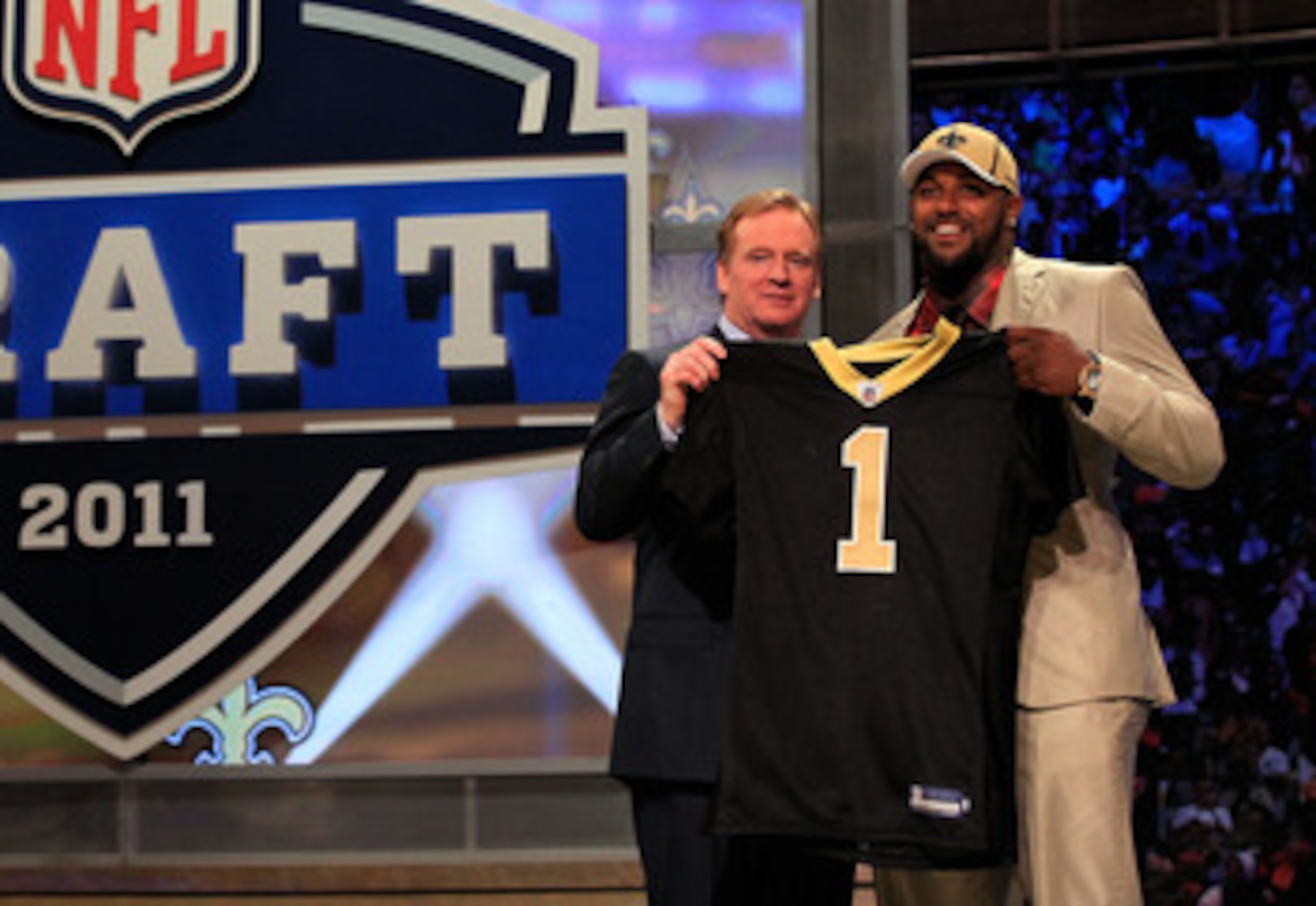 NEW YORK, NY - APRIL 28:  NFL Commissioner Roger Goodell (L) poses for a photo with Cameron Jordan, #24 overall pick by the New Orleans Saints, holds up a jersey on stage during the 2011 NFL Draft at Radio City Music Hall on April 28, 2011 in New York Cit