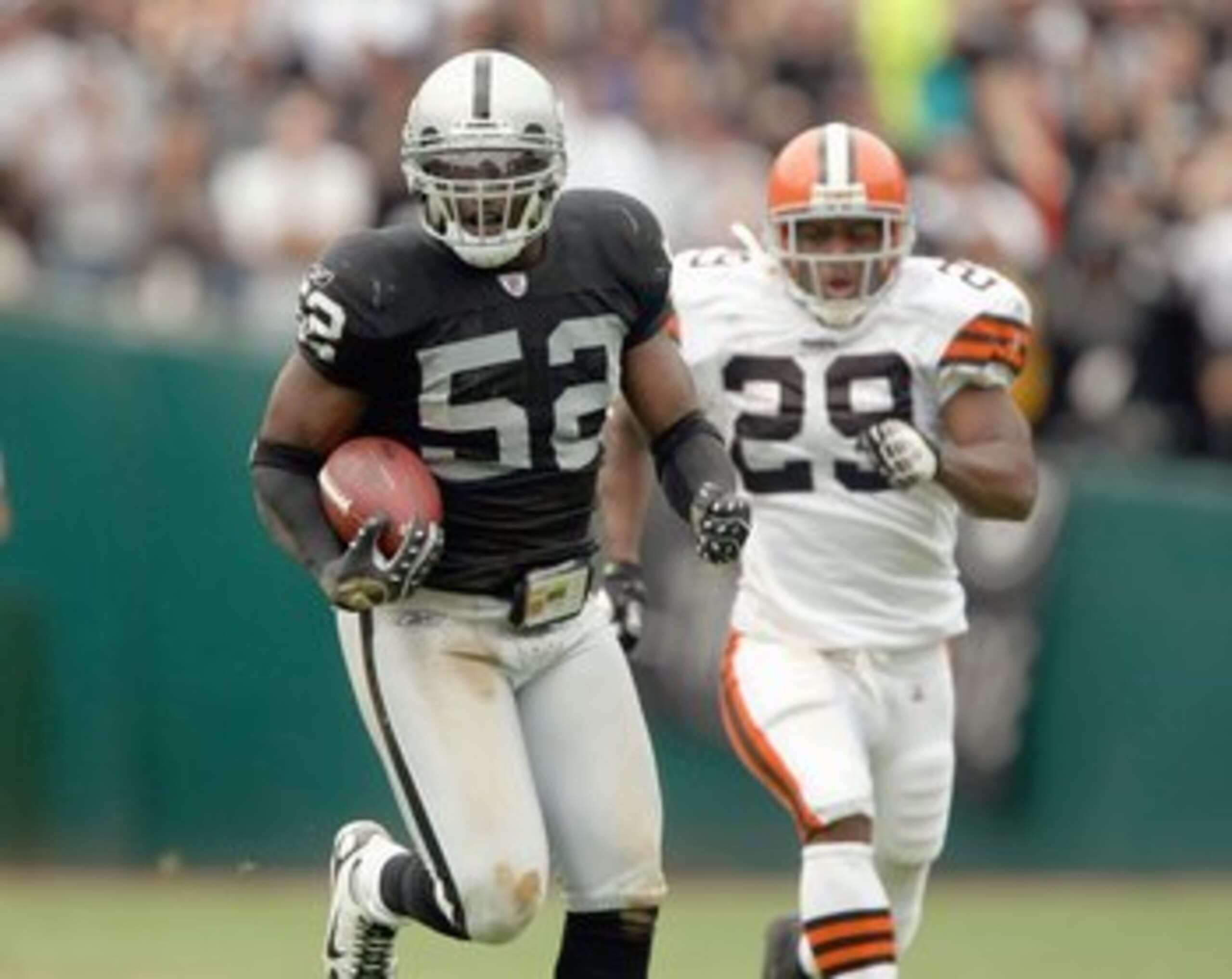 OAKLAND, CA - SEPTEMBER 23: Kirk Morrison #52 of the Oakland Raiders carries the ball during an NFL game against the Cleveland Browns at McAfee Coliseum September 23, 2007 in Oakland, California. (Photo by Jed Jacobsohn/Getty Images)