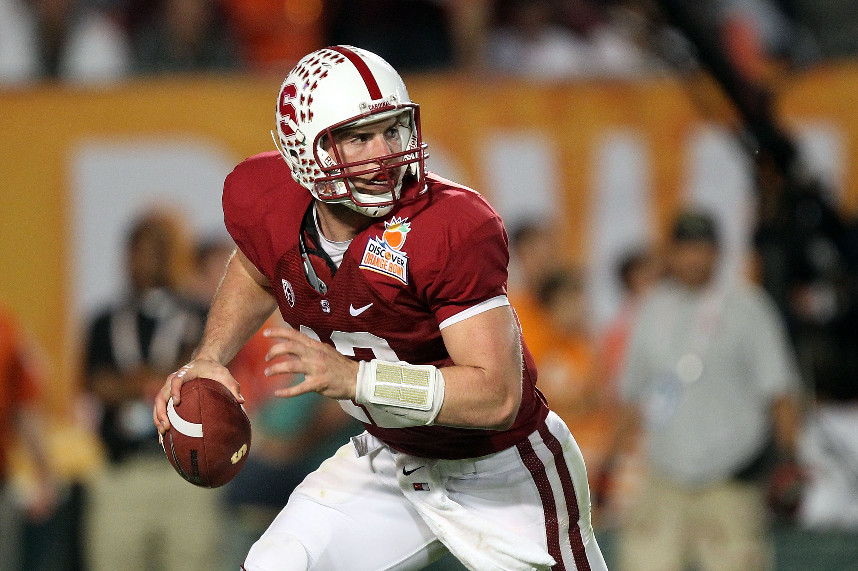 MIAMI, FL - JANUARY 03:  Quarterback Andrew Luck #12 of the Stanford Cardinal rolls out of the pocket against the Virginia Tech Hokies during the 2011 Discover Orange Bowl at Sun Life Stadium on January 3, 2011 in Miami, Florida. Stanford won 40-12. (Phot