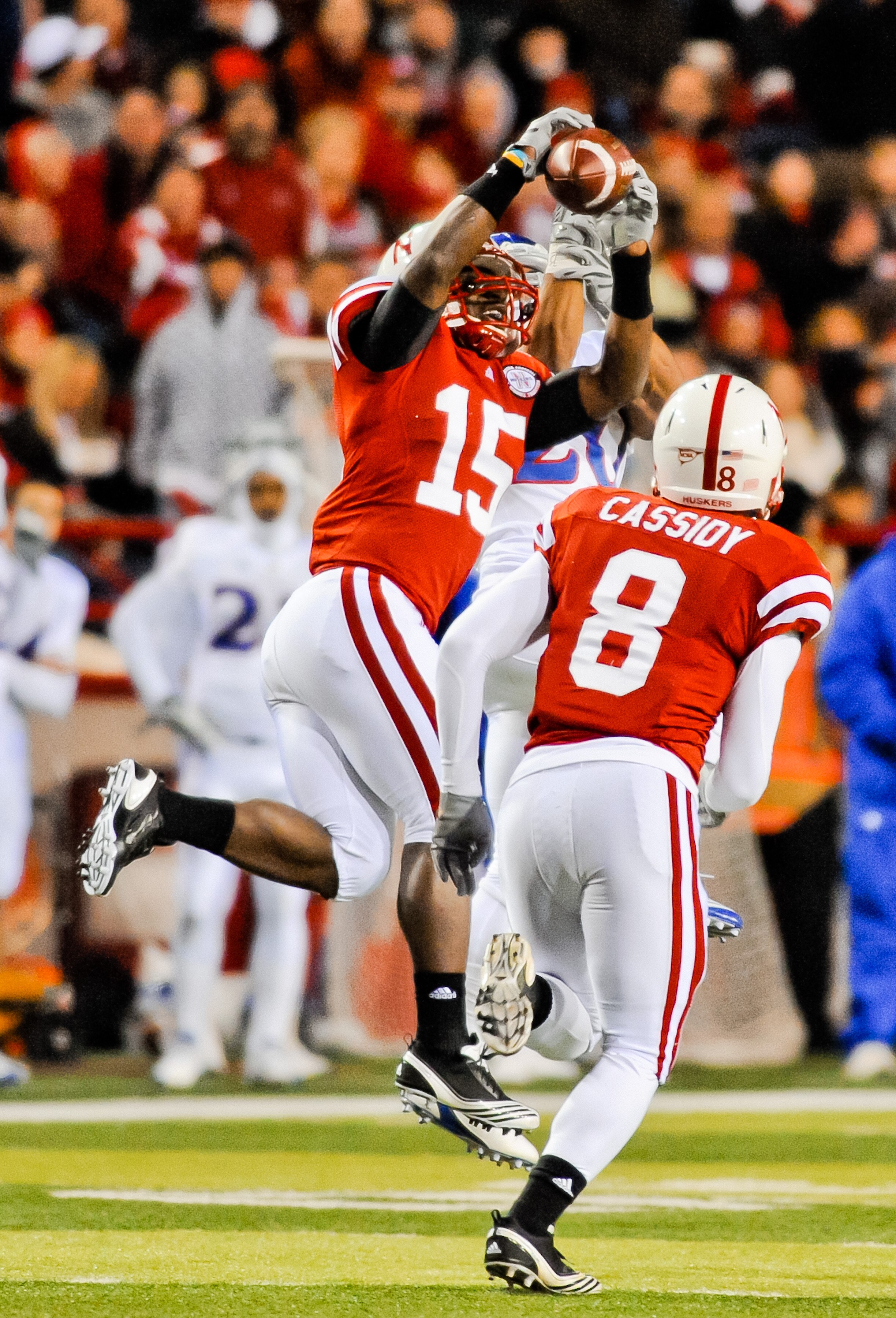LINCOLN, NE - NOVEMBER 13: Alfonzo Dennard #15 of the Nebraska Cornhuskers takes the ball away from D.J. Beshears #20 of the Kansas Jayhawks during second half action of their game at Memorial Stadium on November 13, 2010 in Lincoln, Nebraska. Nebraska De