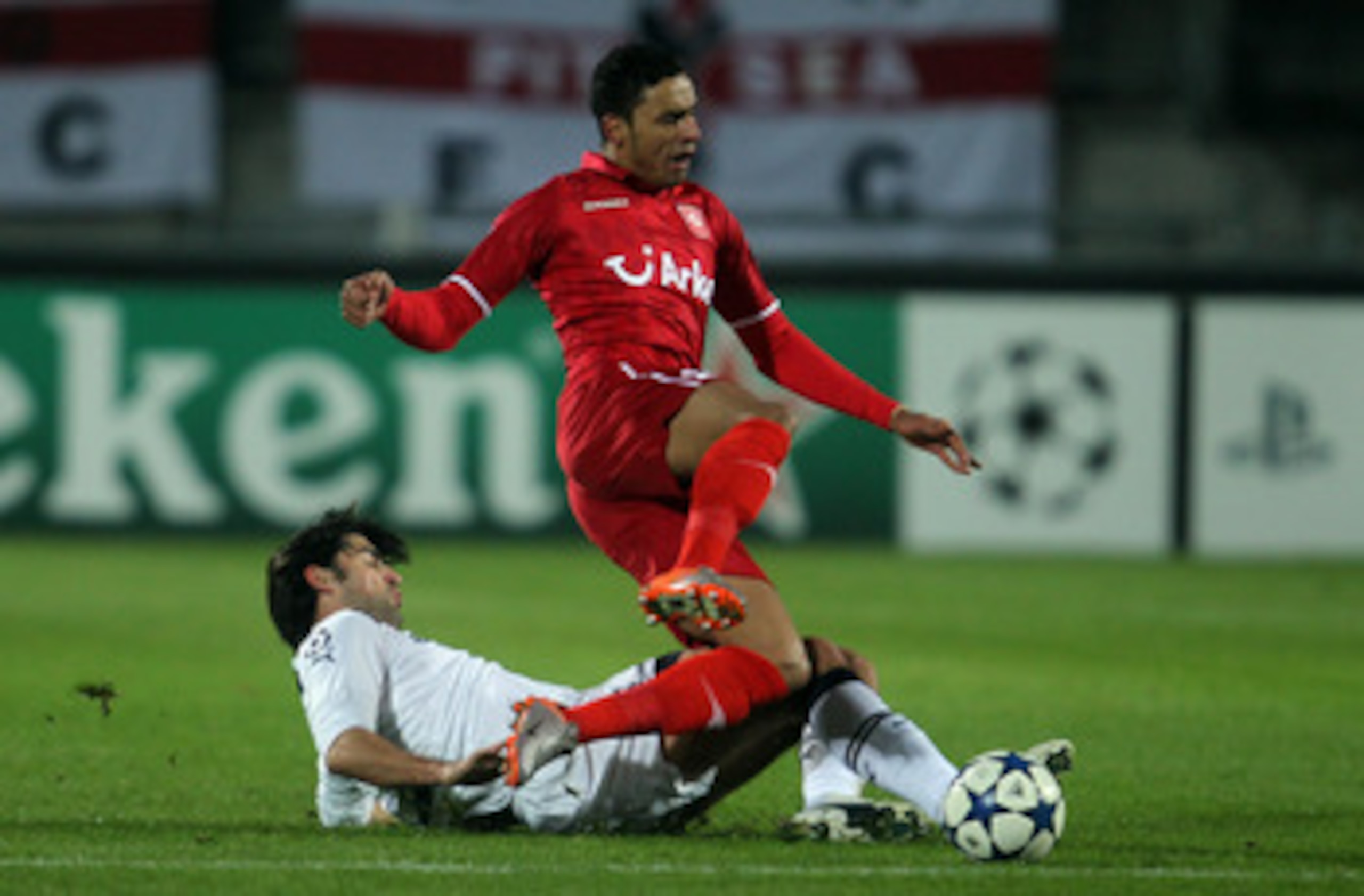 ENSCHEDE, NETHERLANDS - DECEMBER 07: Vedran Corluka of Tottenham challenges Nacer Chadli of Twente during the UEFA Champions League Group A match between FC Twente and Tottenham Hotspur at FC Twente stadium on December 7, 2010 in Enschede, Netherlands.  (