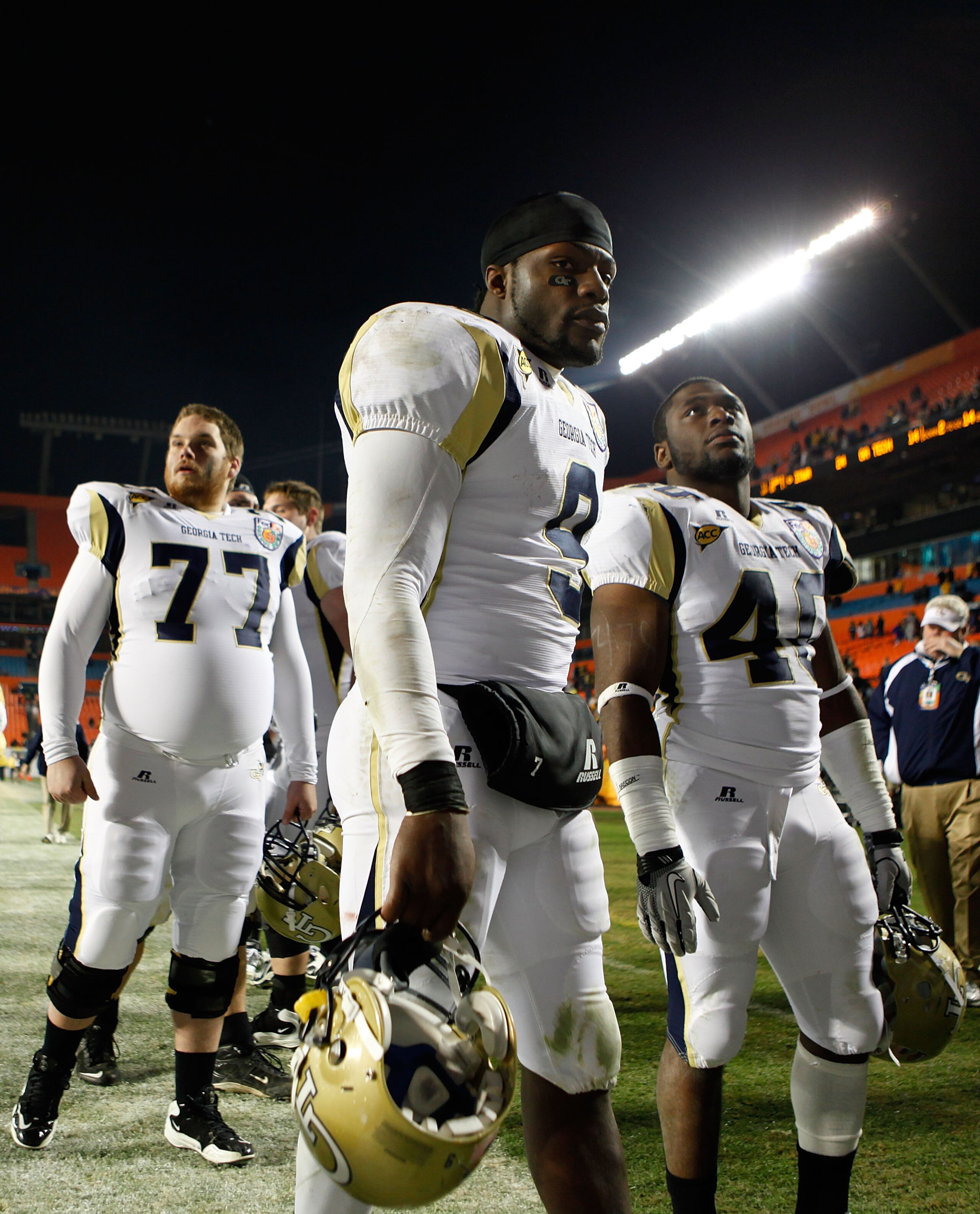 MIAMI GARDENS, FL - JANUARY 05:  (L-R) Dan Voss, Josh Nesbitt #9 and Julian Burnett #40 of the Georgia Tech Yellow Jackets walk off the field dejected after their 24-14 loss against the Iowa Hawkeyes during the FedEx Orange Bowl at Land Shark Stadium on J