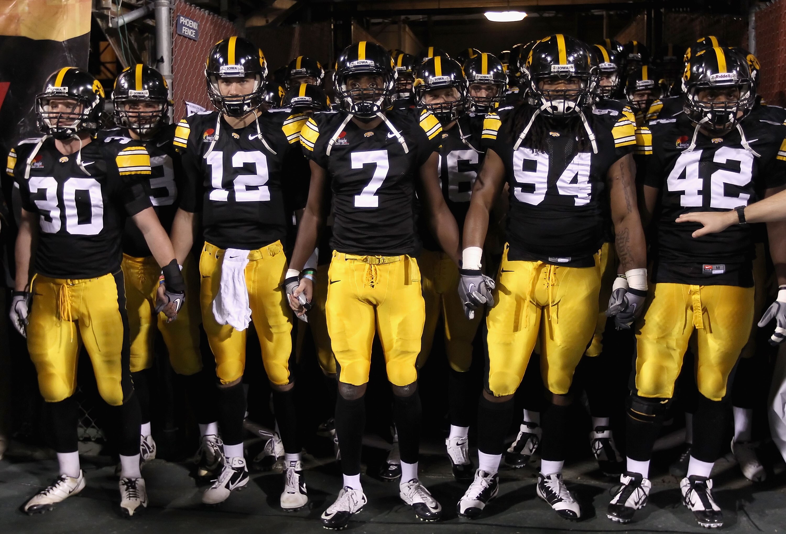 TEMPE, AZ - DECEMBER 28:  (L-R) De'Andre Johnson #30, Ricky Stanzi #12, Marvin McNutt #7, Adrian Clayborn #94 and Jeremiha Hunter #42 of the Iowa Hawkeyes prepare to take the field for the Insight Bowl against the Missouri Tigers at Sun Devil Stadium on D