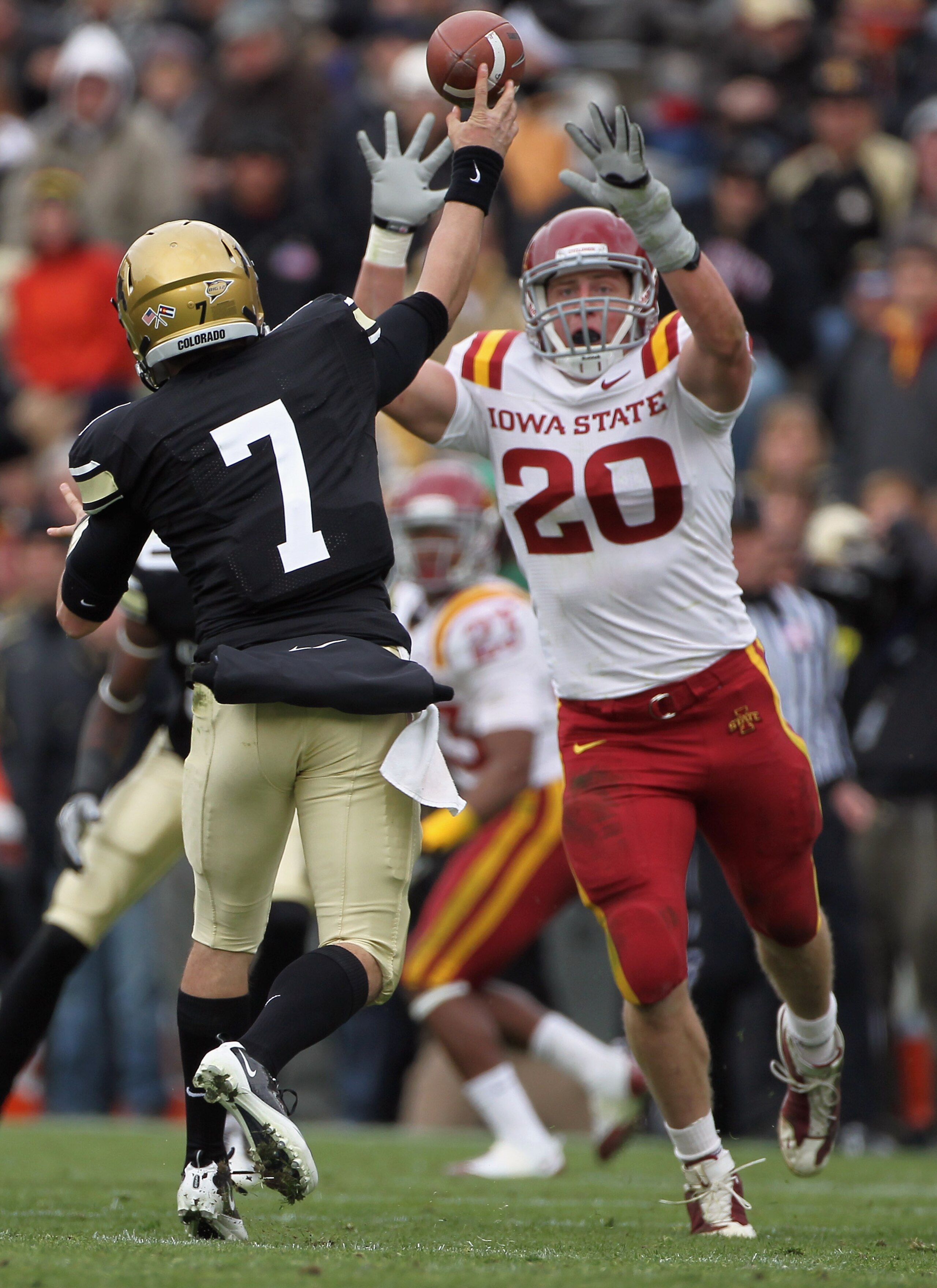 BOULDER, CO - NOVEMBER 13:  Quarterback Cody Hawkins #7 of the Colorado Buffaloes delivers a pass and has it knocked down by Jake Knott #20 of the Iowa State Cyclones at Folsom Field on November 13, 2010 in Boulder, Colorado. Colorado defeated Iowa State 