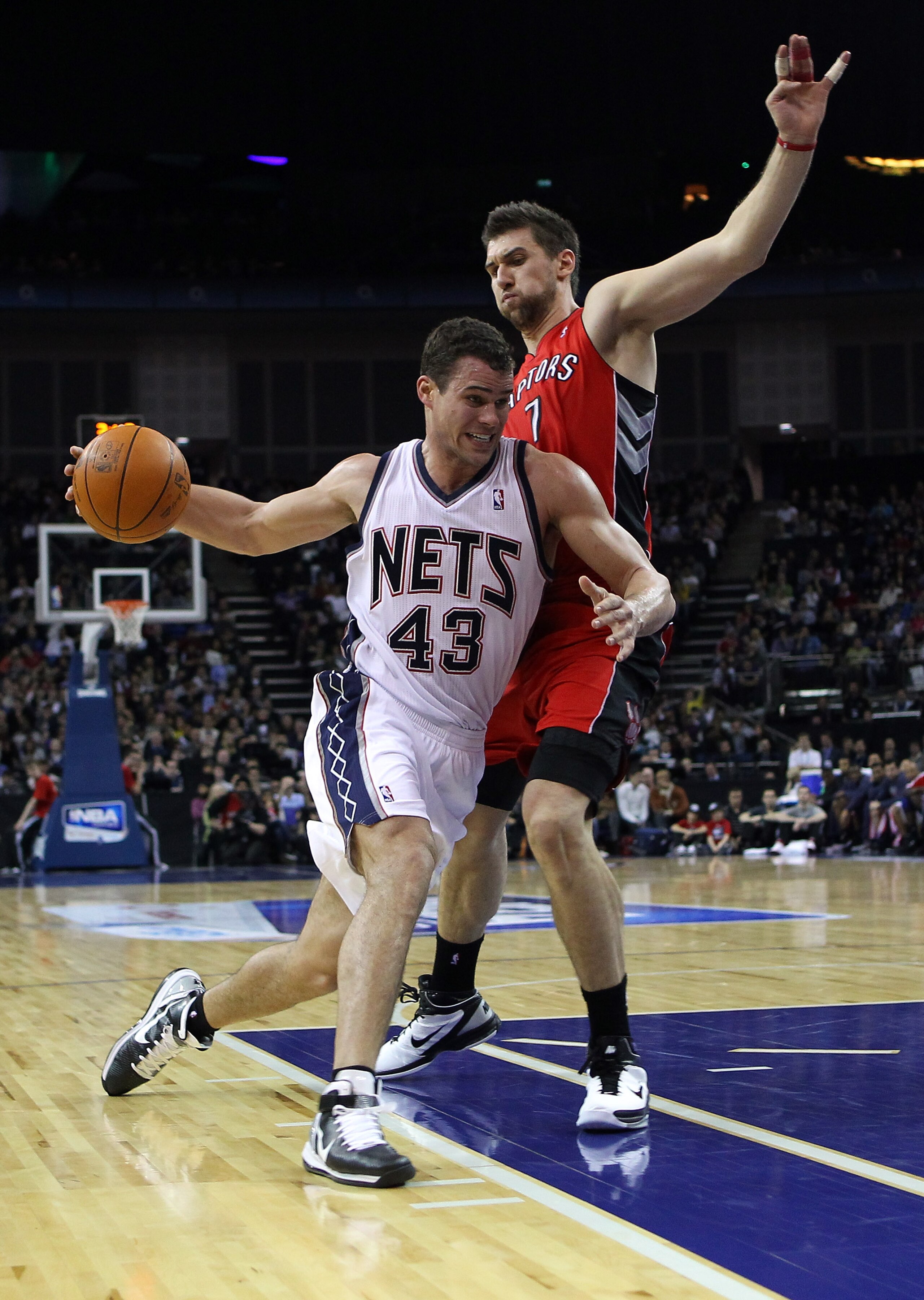LONDON, ENGLAND - MARCH 04:  Kris Humphries of the Nets goes around Andrea Bargnani of the Raptors during the NBA match between New Jersey Nets and the Toronto Raptors at the O2 Arena on March 4, 2011 in London, England. NOTE TO USER: User expressly ackno
