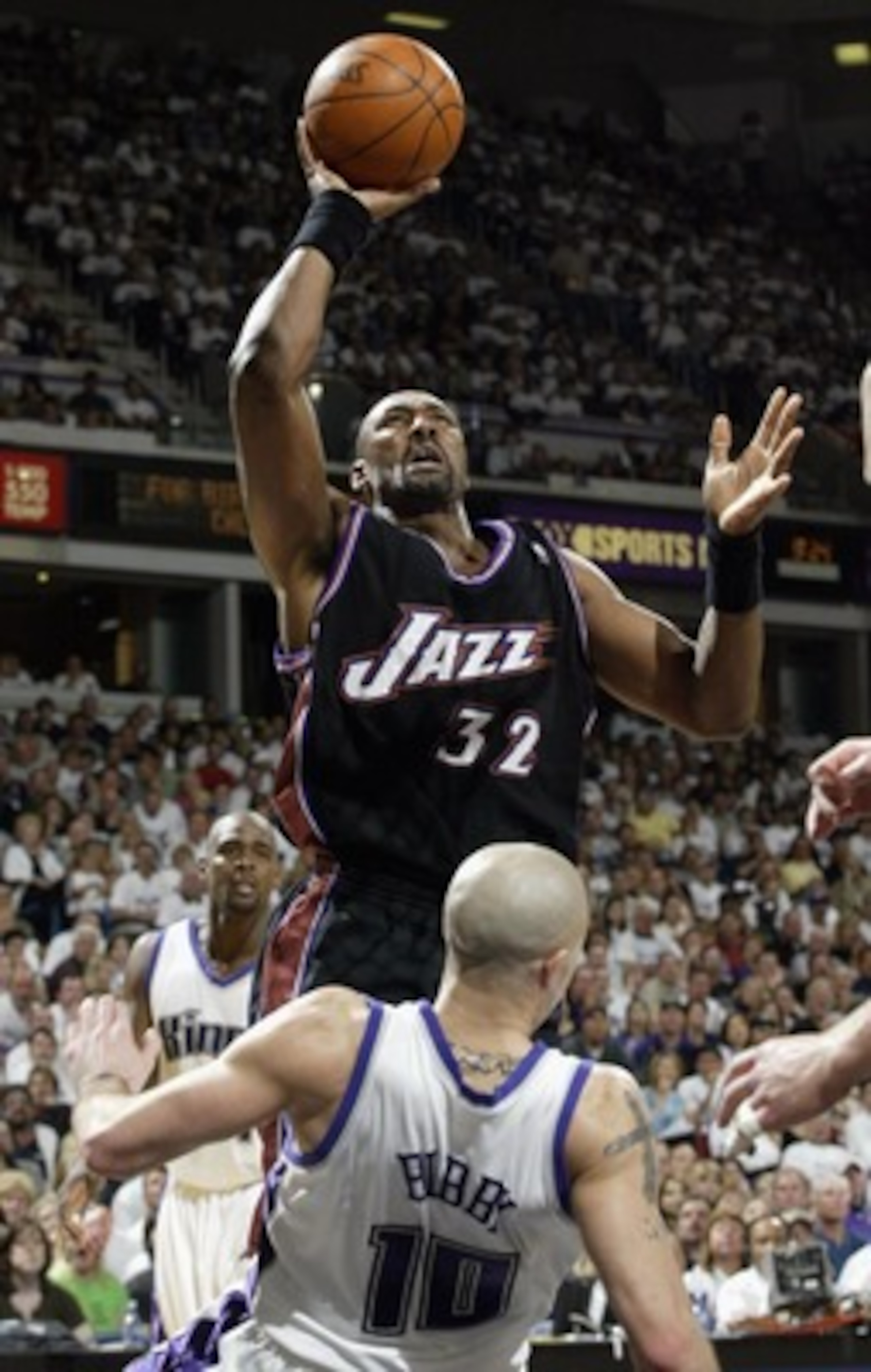 SACRAMENTO, CA - APRIL 19:  Karl Malone #32 of the Utah Jazz shoots over Mike Bibby #10 of the Sacramento Kings in Game one of the Western Conference Quarterfinals during the 2003 NBA Playoffs on April 19, 2003 at Arco Arena in Sacramento, California. (Ph
