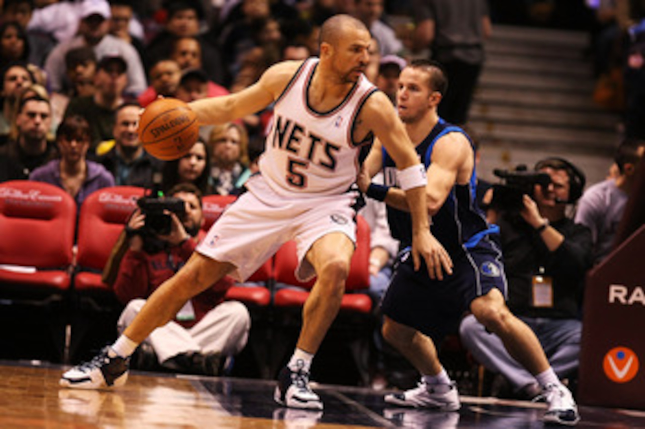 EAST RUTHERFORD, NJ - FEBRUARY 10:  Jason Kidd #5 of the New Jersey Nets leans into Jose Barea #11 of the Dallas Mavericks during their game at the Izod Center February 10, 2008 in East Rutherford, New Jersey.  NOTE TO USER: User expressly acknowledges an