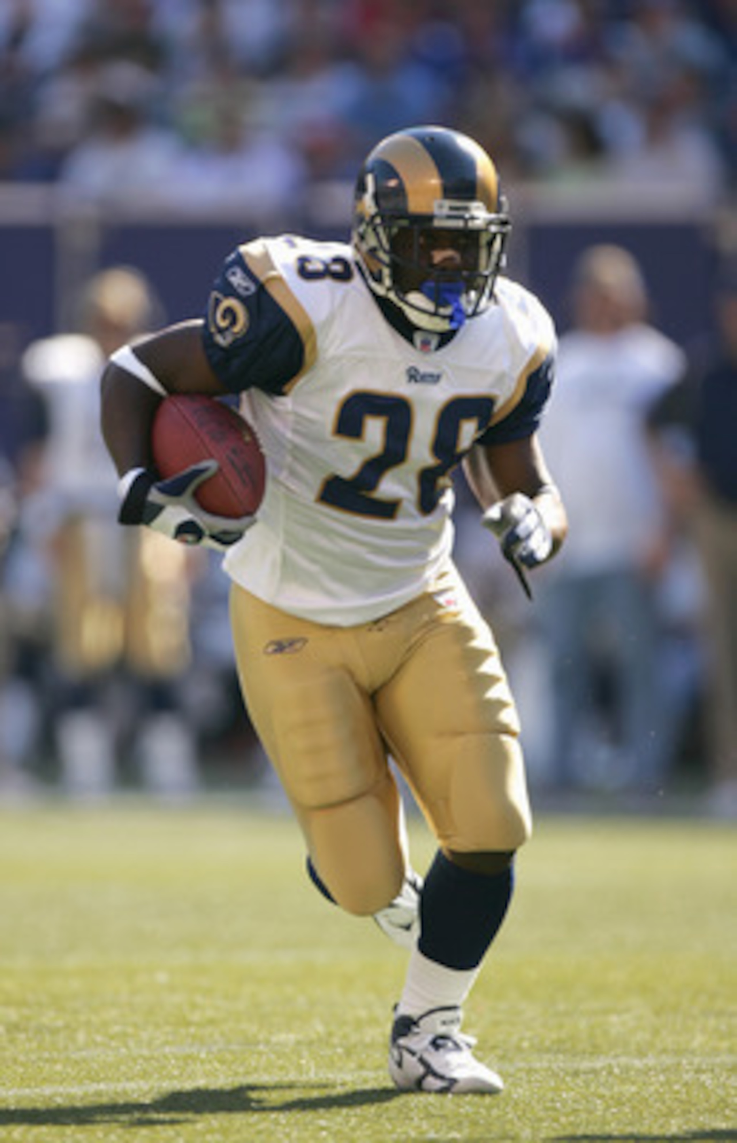 EAST RUTHERFORD, NJ - OCTOBER 02: Marshall Faulk #28 of the St. Louis Rams carries the ball during the game against the New York Giants on October 2, 2005 at Giants Stadium in East Rutherford, New Jersey. The Giants won 44-24. (Photo by Ezra Shaw/Getty Im