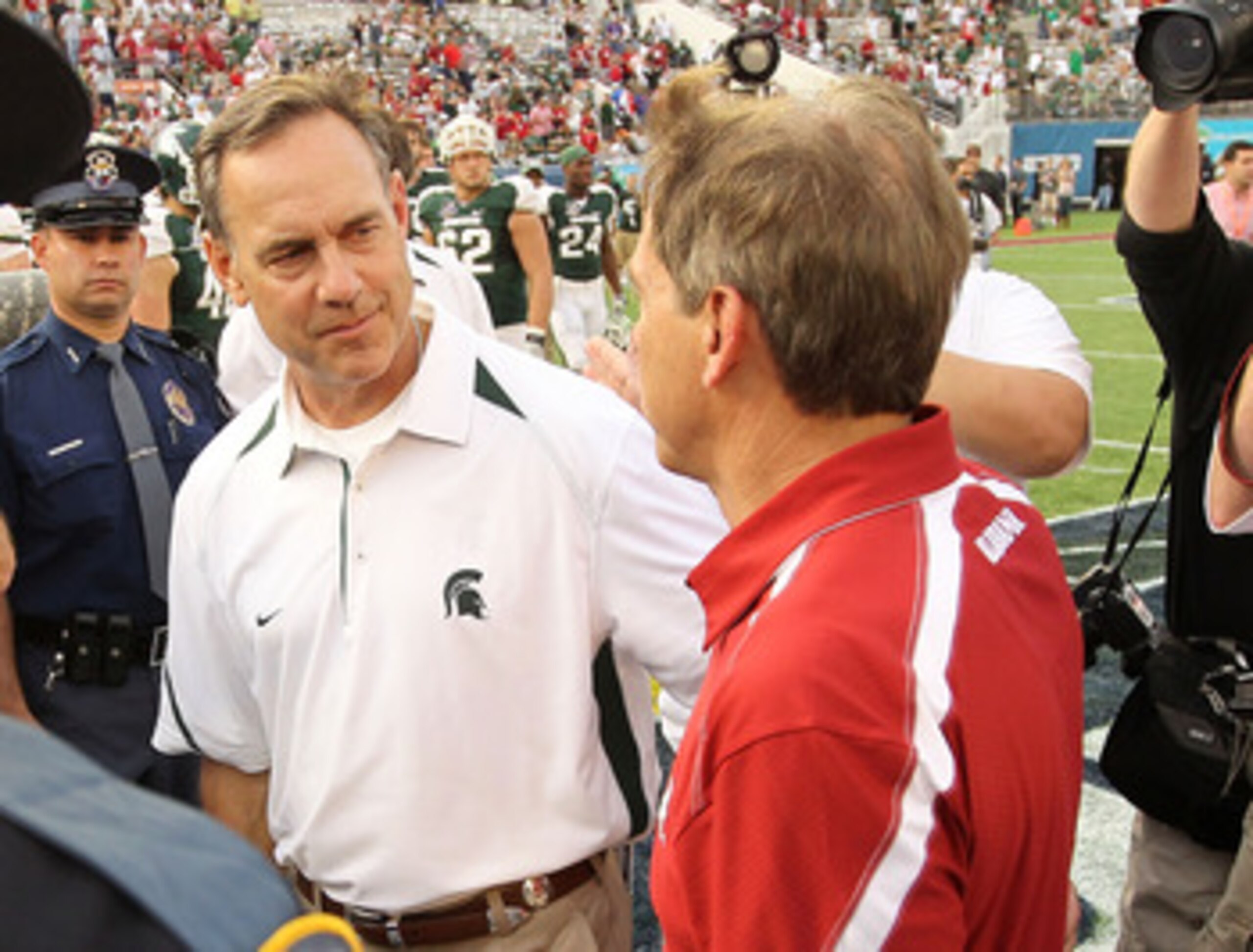 ORLANDO, FL - JANUARY 01:  Alabama Crimson Tide Head Coach Nick Saban greets Michigan State Spartans Head Coach Mark Dantonio after winning the Capitol One Bowl against at the Florida Citrus Bowl on January 1, 2011 in Orlando, Florida.  (Photo by Mike Ehr