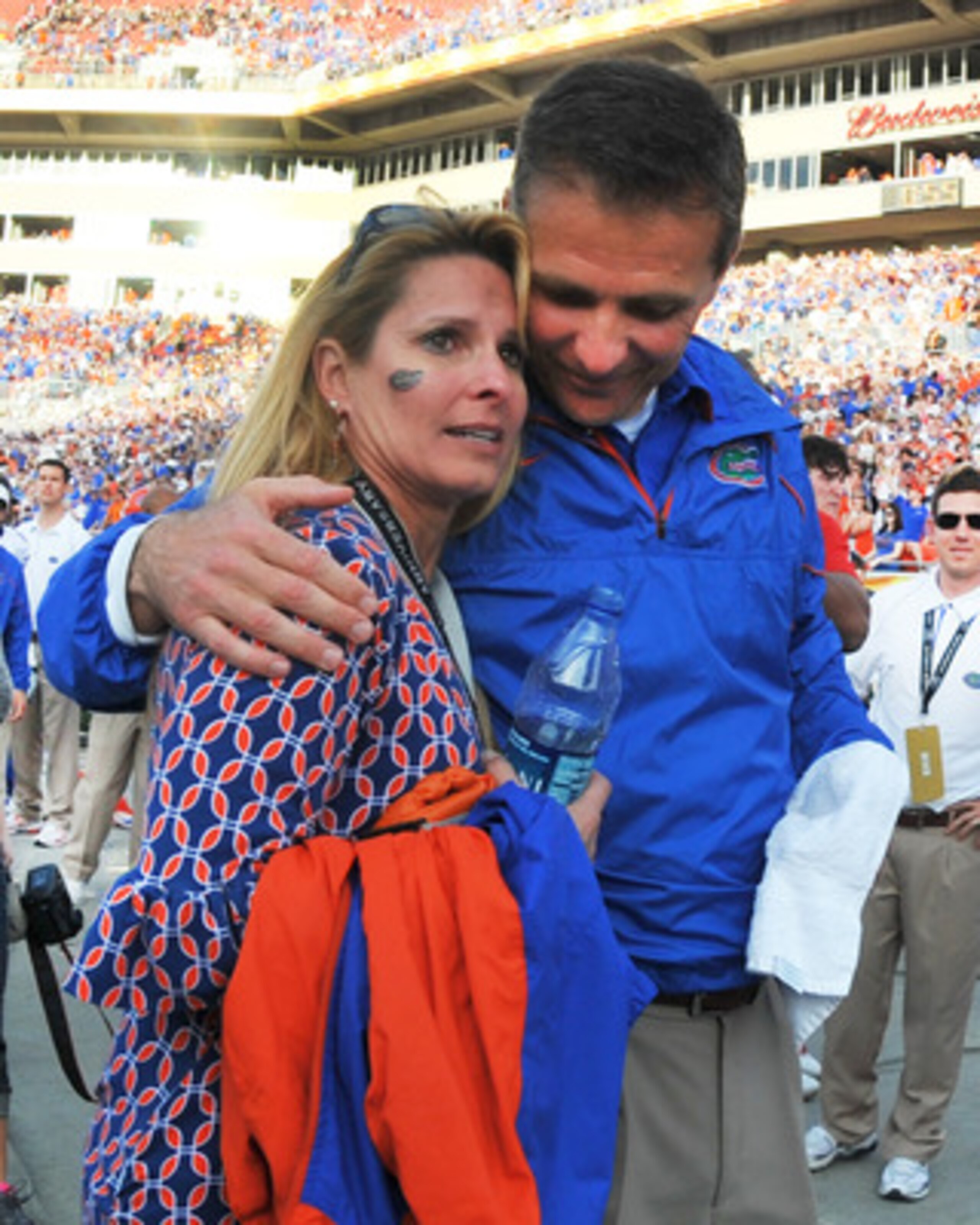 TAMPA, FL - JANUARY 1: Coach Urban Meyer of the Florida Gators hugs his wife, Shelley, after play against the Penn State Nittany Lions January 1, 2011 in the 25th Outback Bowl at Raymond James Stadium in Tampa, Florida. (Photo by Al Messerschmidt/Getty TAMPA, FL - JANUARY 1: Coach Urban Meyer of the Florida Gators hugs his wife, Shelley, after play against the Penn State Nittany Lions January 1, 2011 in the 25th Outback Bowl at Raymond James Stadium in Tampa, Florida. (Photo by Al Messerschmidt/Getty