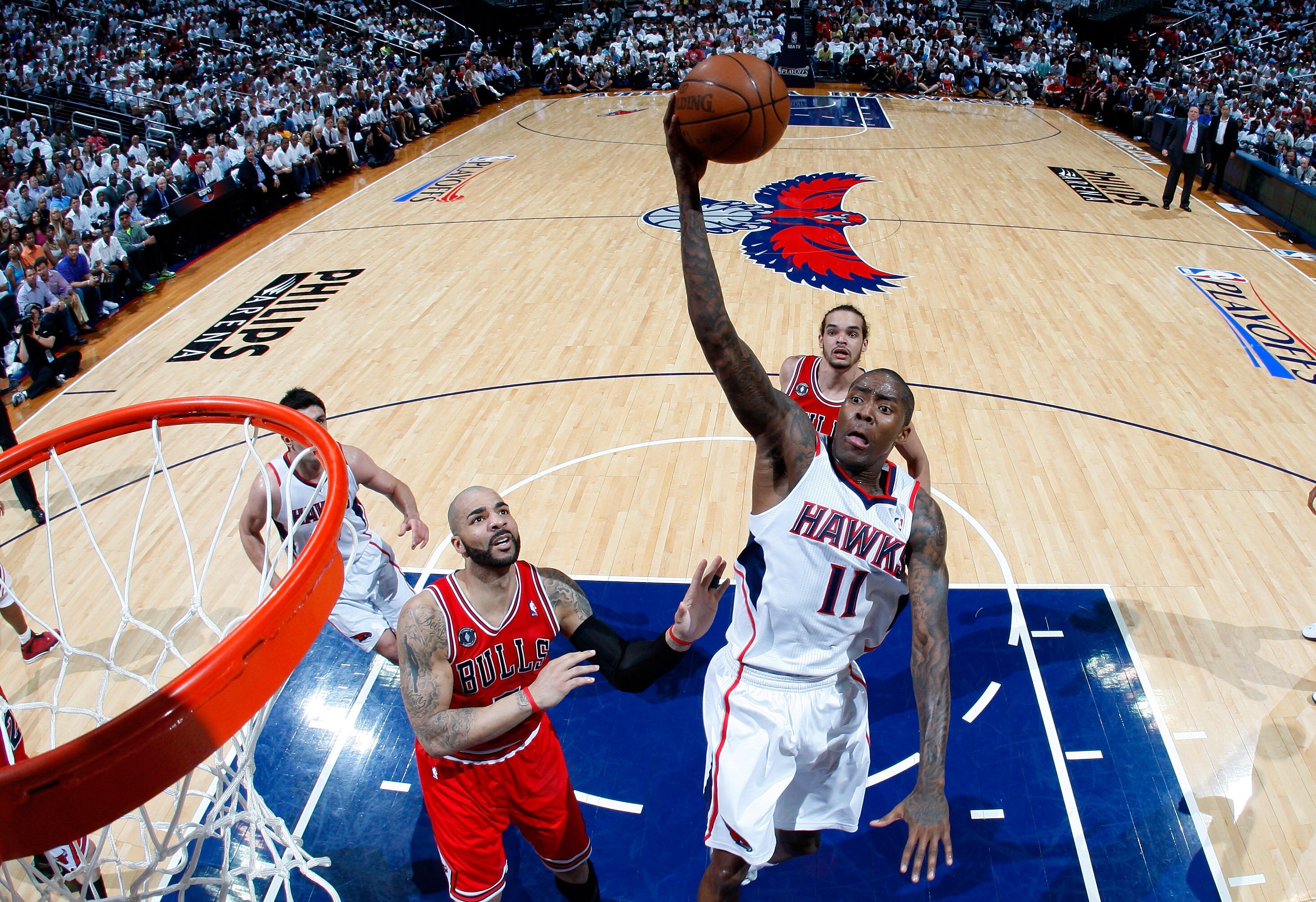 ATLANTA, GA - MAY 12:  Jamal Crawford #11 of the Atlanta Hawks drives the basket against Carlos Boozer #5 of the Chicago Bulls in Game Six of the Eastern Conference Semifinals in the 2011 NBA Playoffs at Phillips Arena on May 12, 2011 in Atlanta, Georgia.