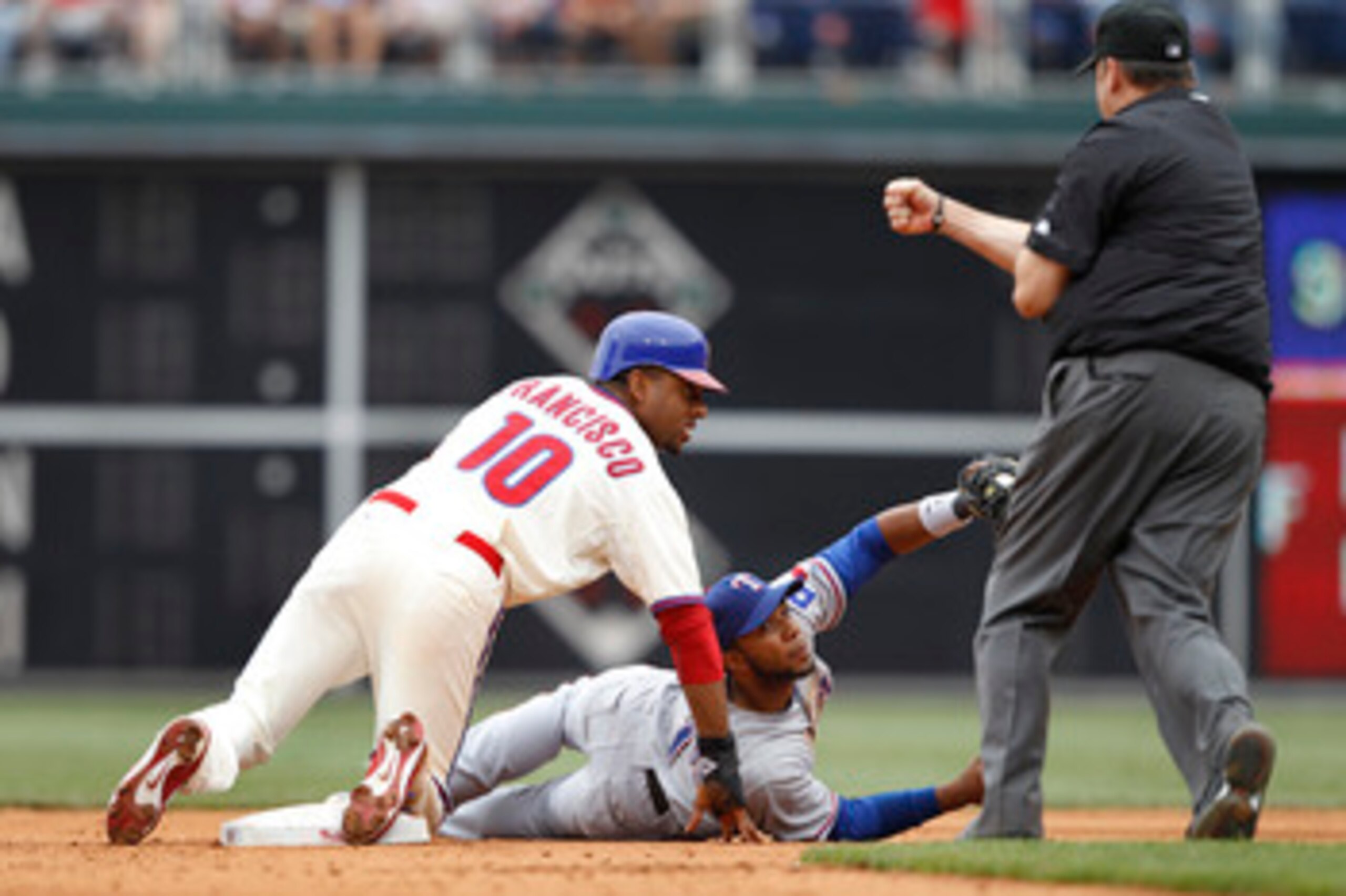 PHILADELPHIA, PA - MAY 22: Elvis Andrus #1 of the Texas Rangers tags out Ben Francisco #10 of the Philadelphia Phillies during a play at second base at Citizens Bank Park on May 22, 2011 in Philadelphia, Pennsylvania. The Rangers won 2-0. (Photo by Joe Ro