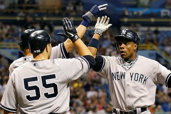 ST. PETERSBURG, FL - MAY 16:  Outfielder Curtis Granderson #14 of the New York Yankees is congratulated by Derek Jeter #2 and Russell Martin #55 after this fifth inning three run home run against the Tampa Bay Rays during the game at Tropicana Field on Ma
