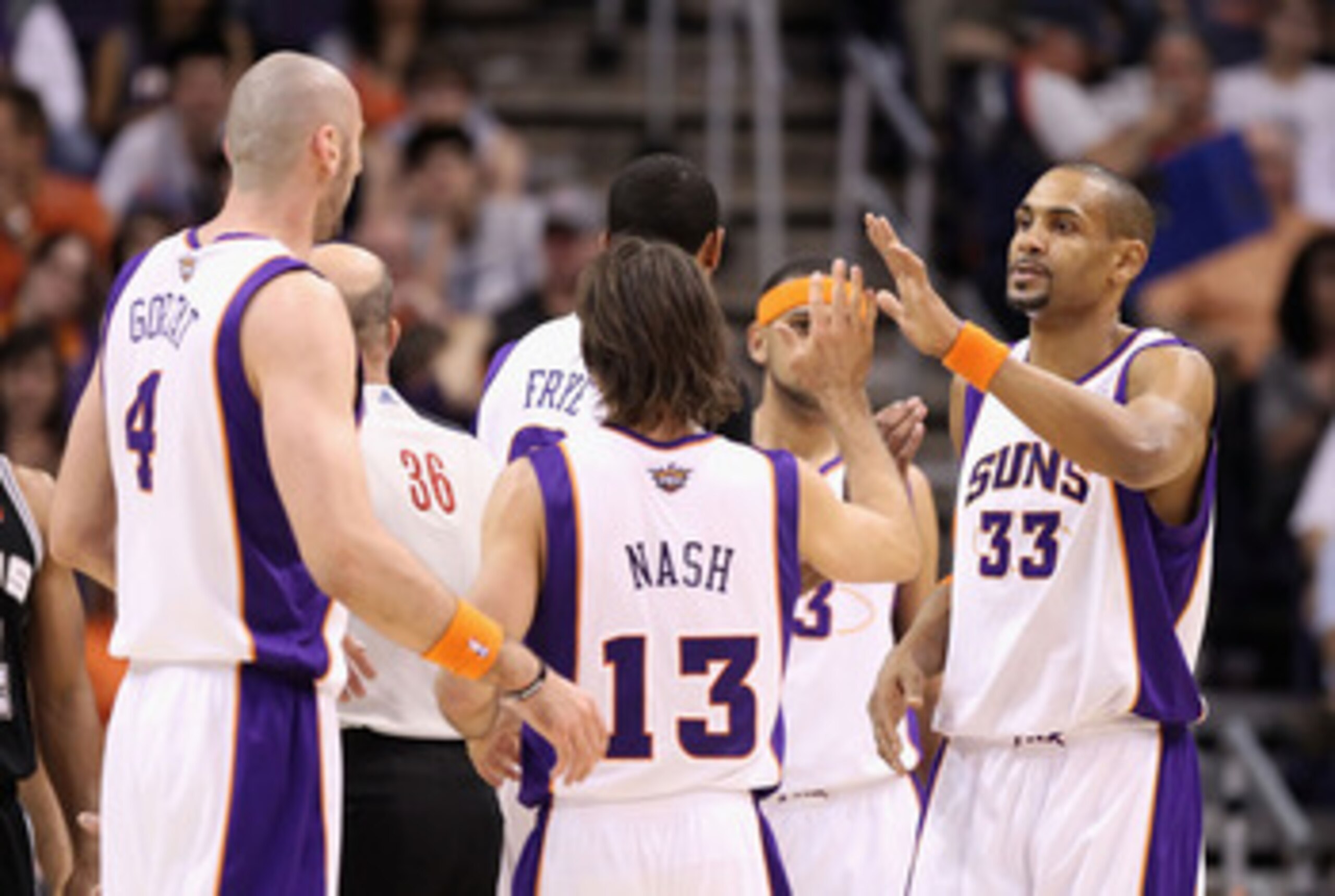 PHOENIX, AZ - APRIL 13:  Grant Hill #33 of the Phoenix Suns high fives teammates Steve Nash #13 and Marcin Gortat #4 after scoring against the San Antonio Spurs during the NBA game at US Airways Center on April 13, 2011 in Phoenix, Arizona.  NOTE TO USER: