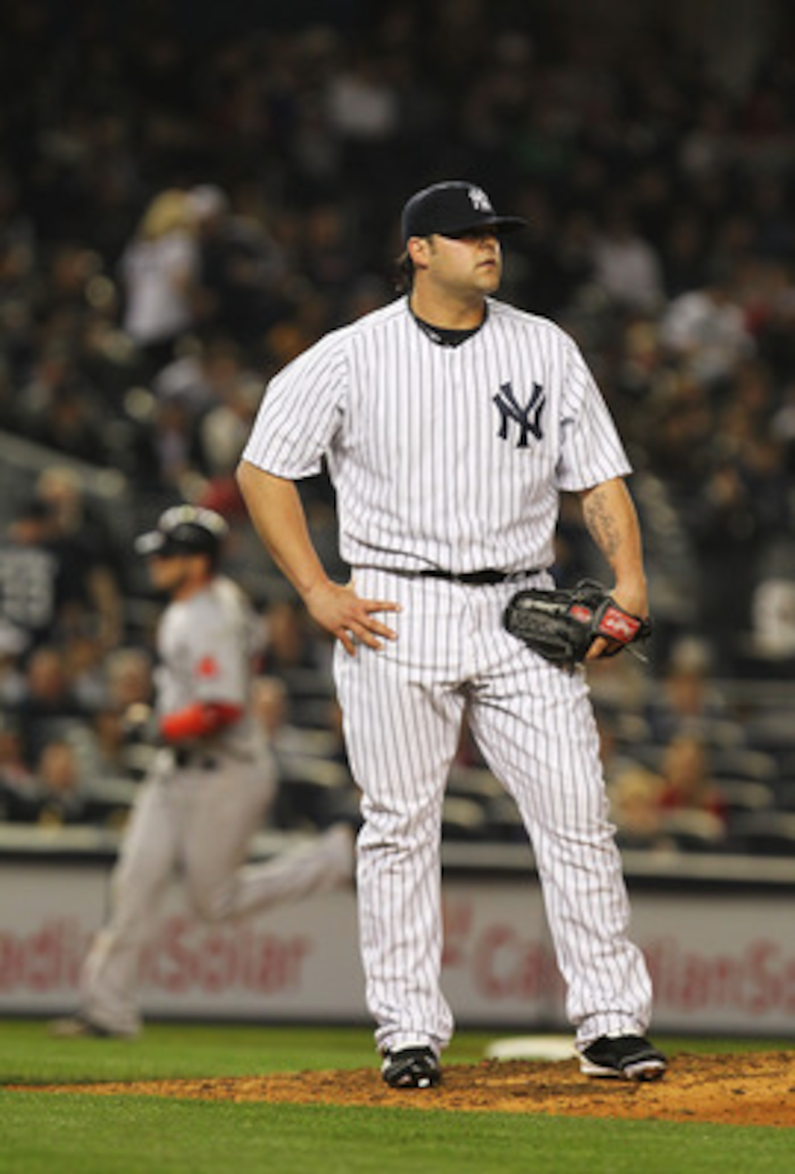 NEW YORK, NY - MAY 15:  Joba Chamberlain #62 of the New York Yankees reacts after giving up a home run against Jarrod Saltalamacchia #39 of the Boston Red Sox during their game on May 15, 2011 at Yankee Stadium in the Bronx borough of New York City.  (Pho