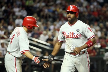 PHOENIX, AZ - APRIL 26:  Ben Francisco #10 of the Philadelphia Phillies high fives teammate Shane Victorino #8 after scoring a sixth inning run against the Arizona Diamondbacks during the Major League Baseball game at Chase Field on April 26, 2011 in Phoe