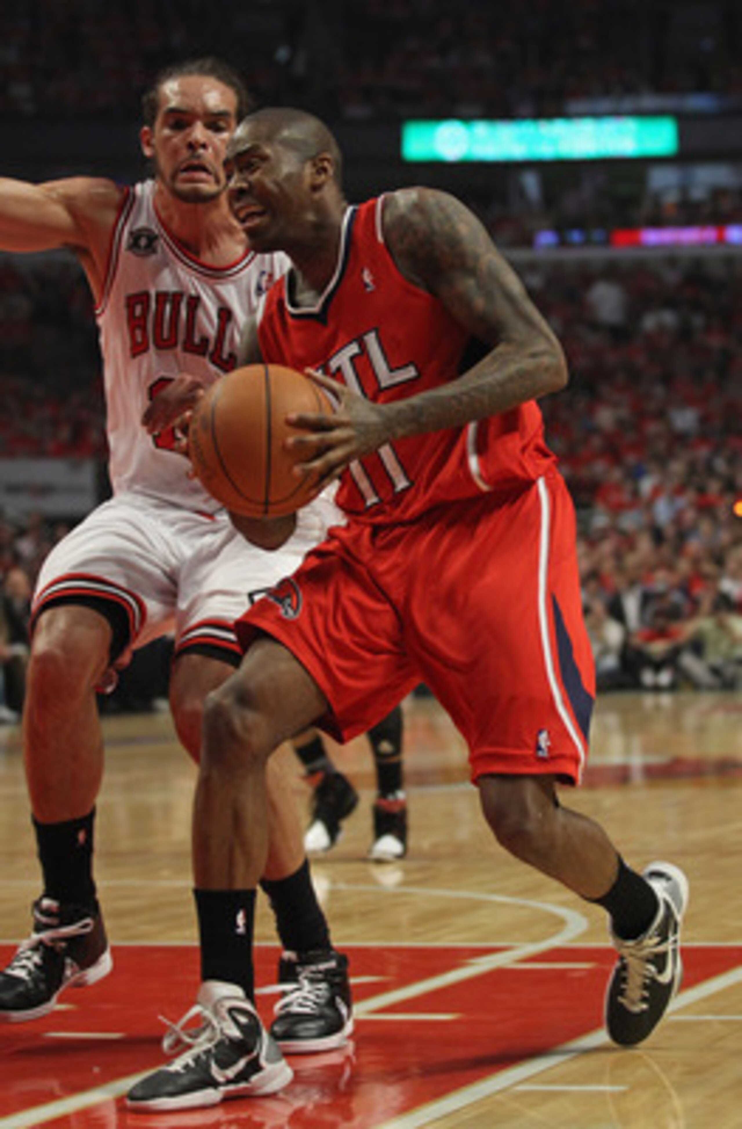 CHICAGO, IL - MAY 10: Jamal Crawford #11 of the Atlanta Hawks drives past Joakim Noah #13 of the Chicago Bulls in Game Five of the Eastern Conference Semifinals in the 2011 NBA Playoffs at the United Center on May 10, 2011 in Chicago, Illinois. The Bulls 