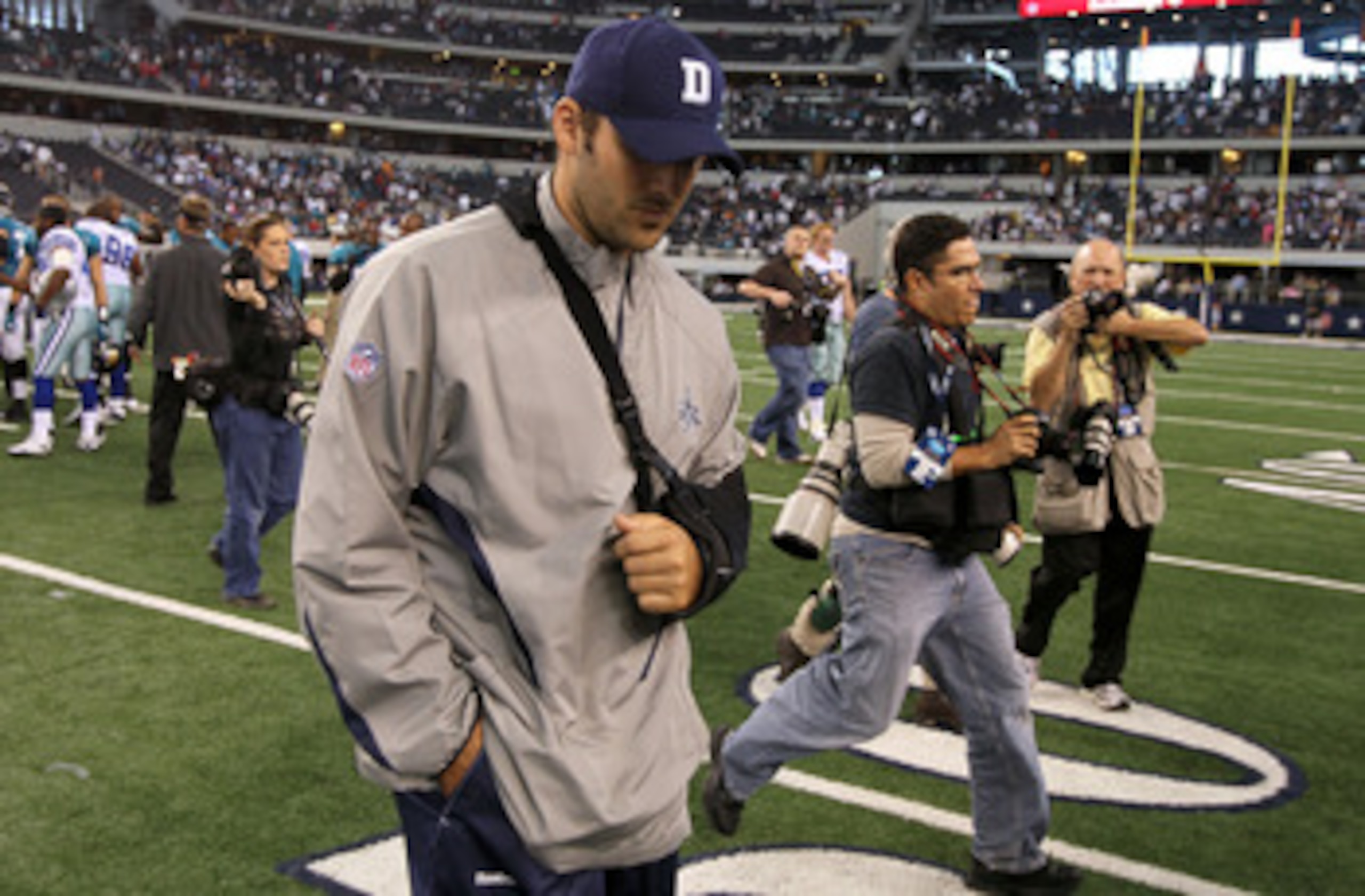 ARLINGTON, TX - OCTOBER 31:  Injured quarterback Tony Romo of the Dallas Cowboys walks off the field with his head down after the Cowboys lost 35-17 against the Jacksonville Jaguars at Cowboys Stadium on October 31, 2010 in Arlington, Texas.  (Photo by St