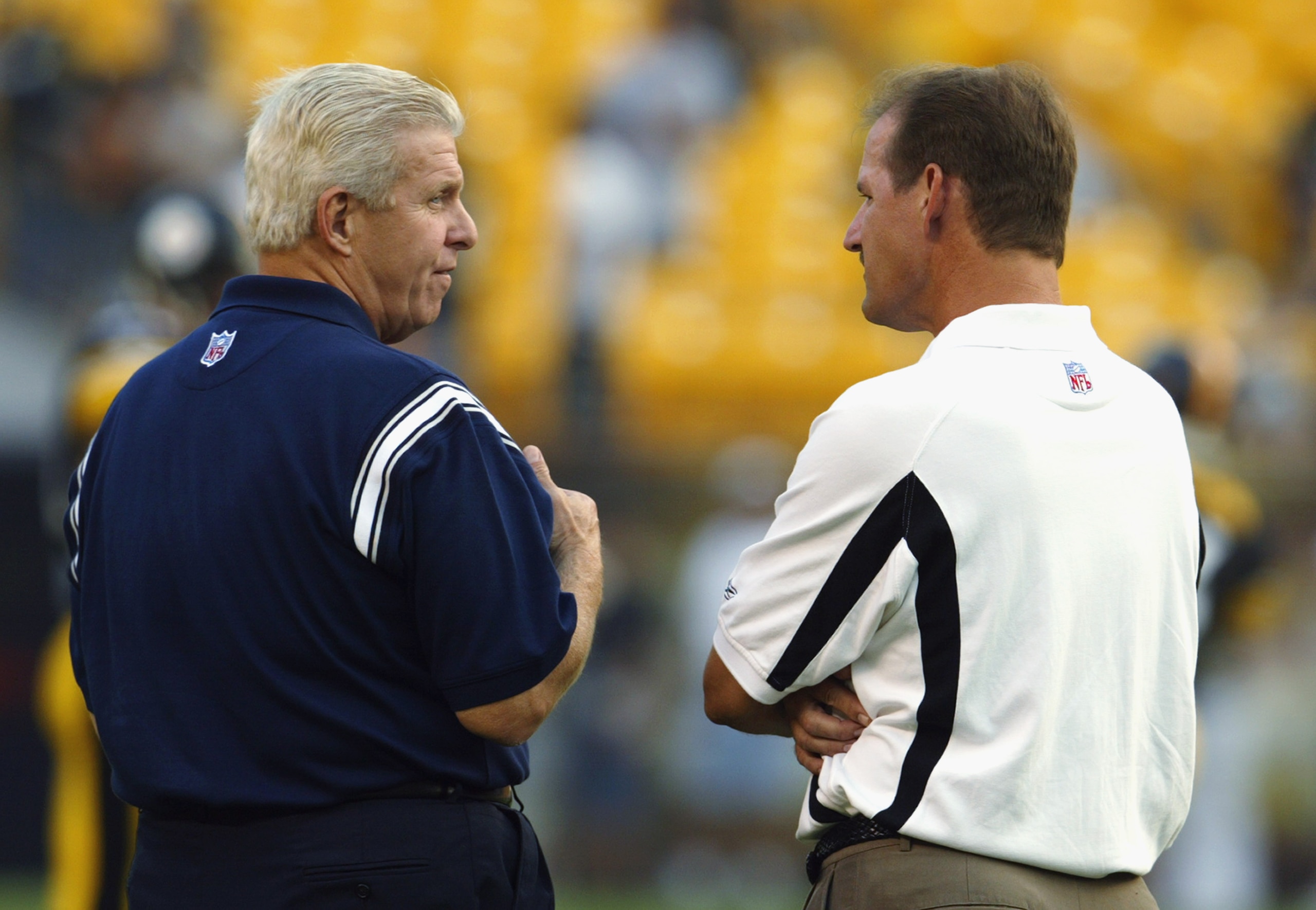 PITTSBURGH - AUGUST 21:  Head coach Bill Parcells (L) of the Dallas Cowboys talks to head coach Bill Cowher of the Pittsburgh Steelers prior to the NFL preseason game at the Heinze Field on August 21, 2003 in Pittsburgh, Pennsylvania. The Steelers defeate