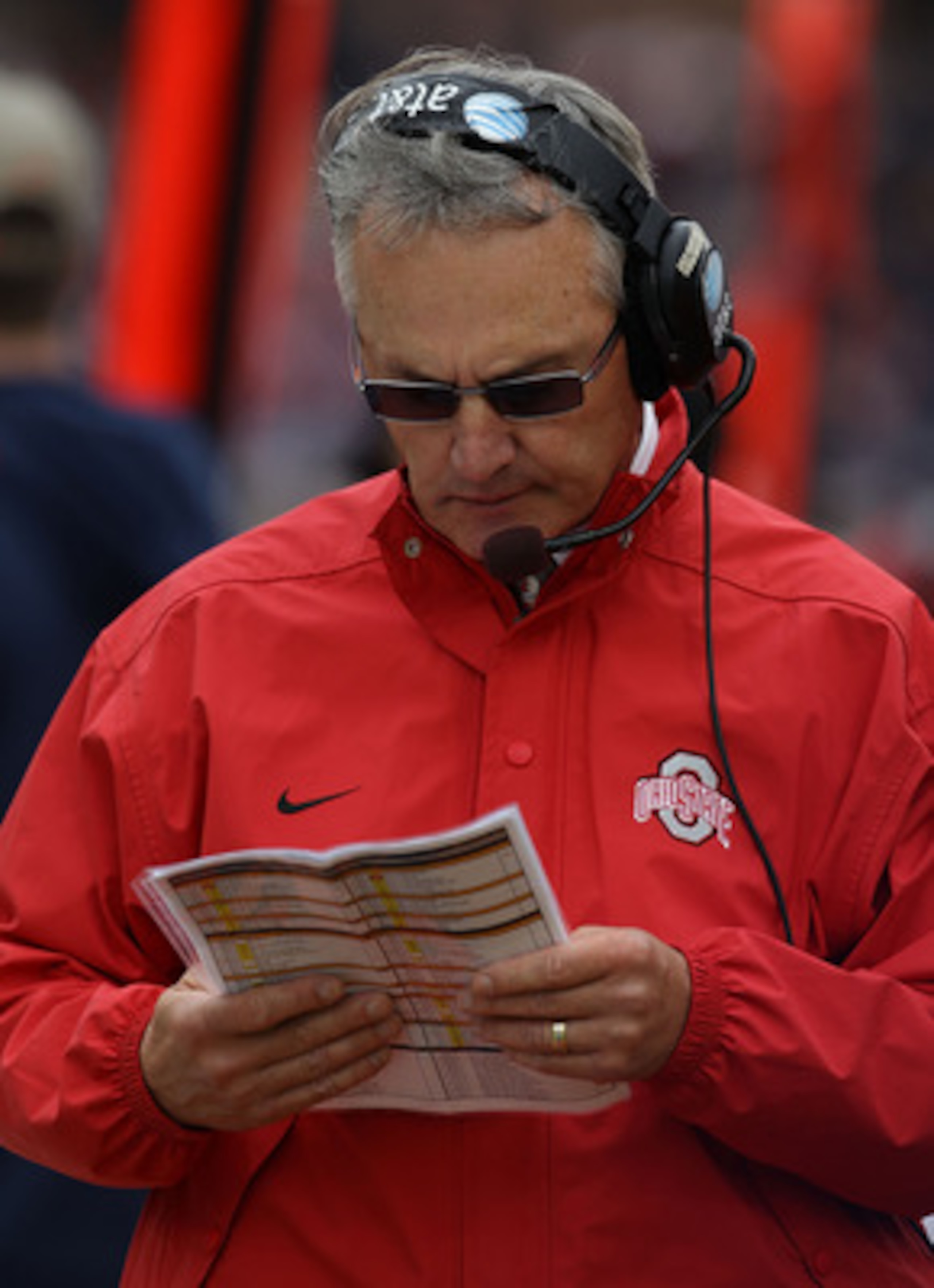 CHAMPAIGN, IL - OCTOBER 02: Head coach Jim Tressell of the Ohio State Buckeyes checks his play list during a game against the Illinois Fighting Illini at Memorial Stadium on October 2, 2010 in Champaign, Illinois. Ohio State defeated Illinois 24-13. (Phot