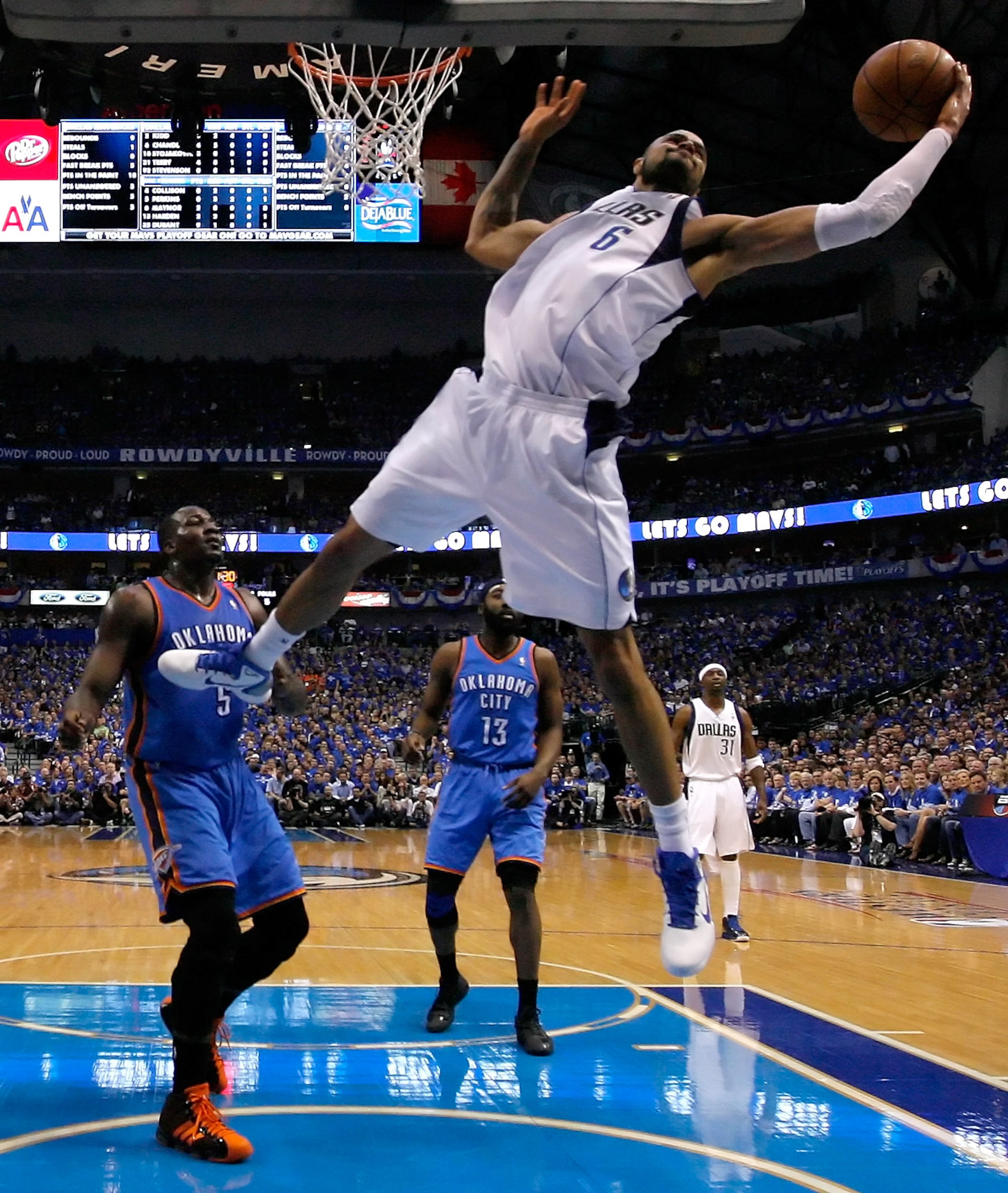 DALLAS, TX - MAY 19:  Tyson Chandler #6 of the Dallas Mavericks rebounds the ball in front of Kendrick Perkins #5 of the Oklahoma City Thunder in the first half in Game Two of the Western Conference Finals during the 2011 NBA Playoffs at American Airlines
