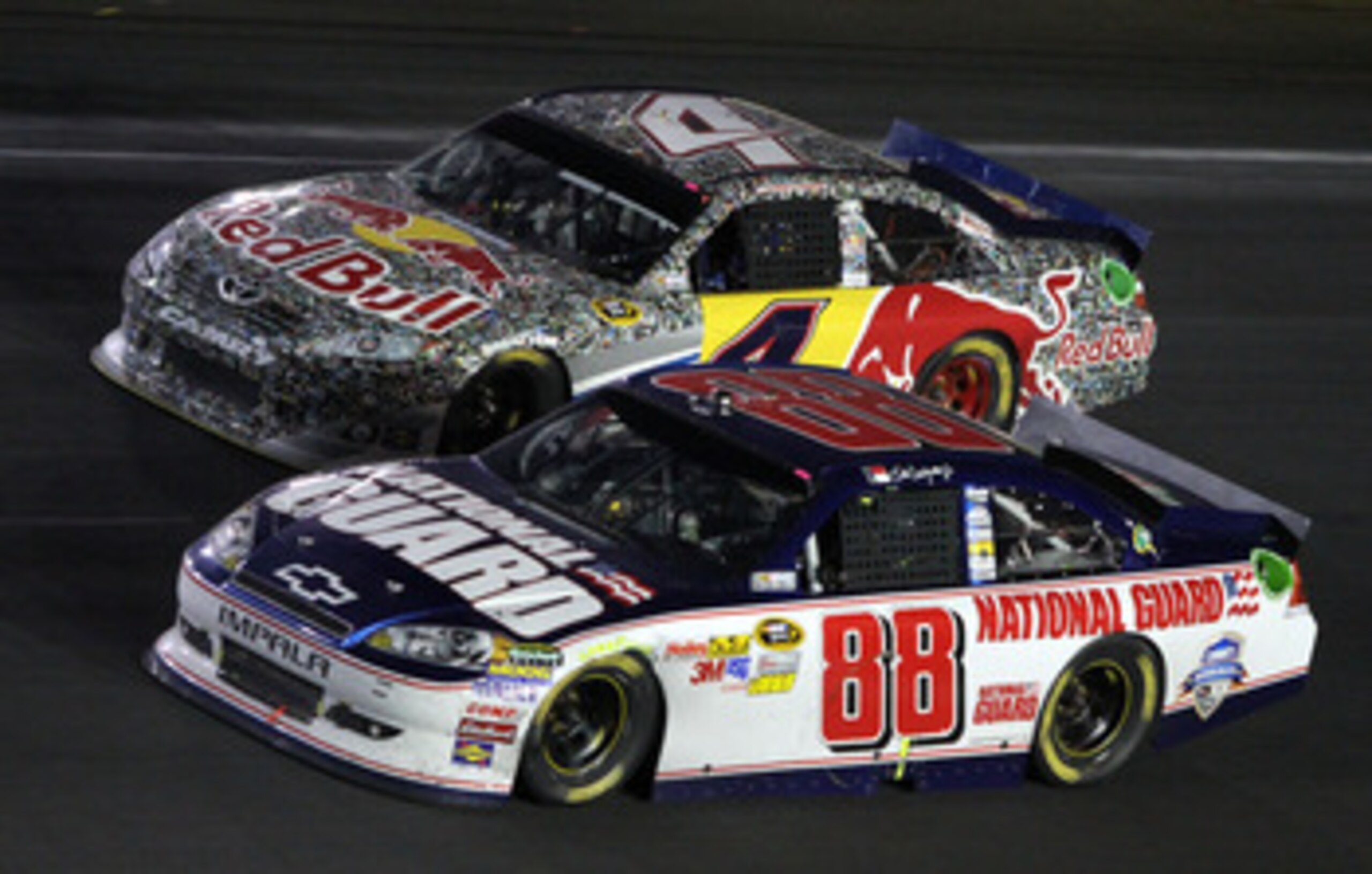 CONCORD, NC - MAY 29:  Dale Earnhardt Jr., driver of the #88 National Guard/Amp Energy Chevrolet, races side by side with Kasey Kahne, driver of the #4 Red Bull Toyota, during the NASCAR Sprint Cup Series Coca-Cola 600 at Charlotte Motor Speedway on May 2