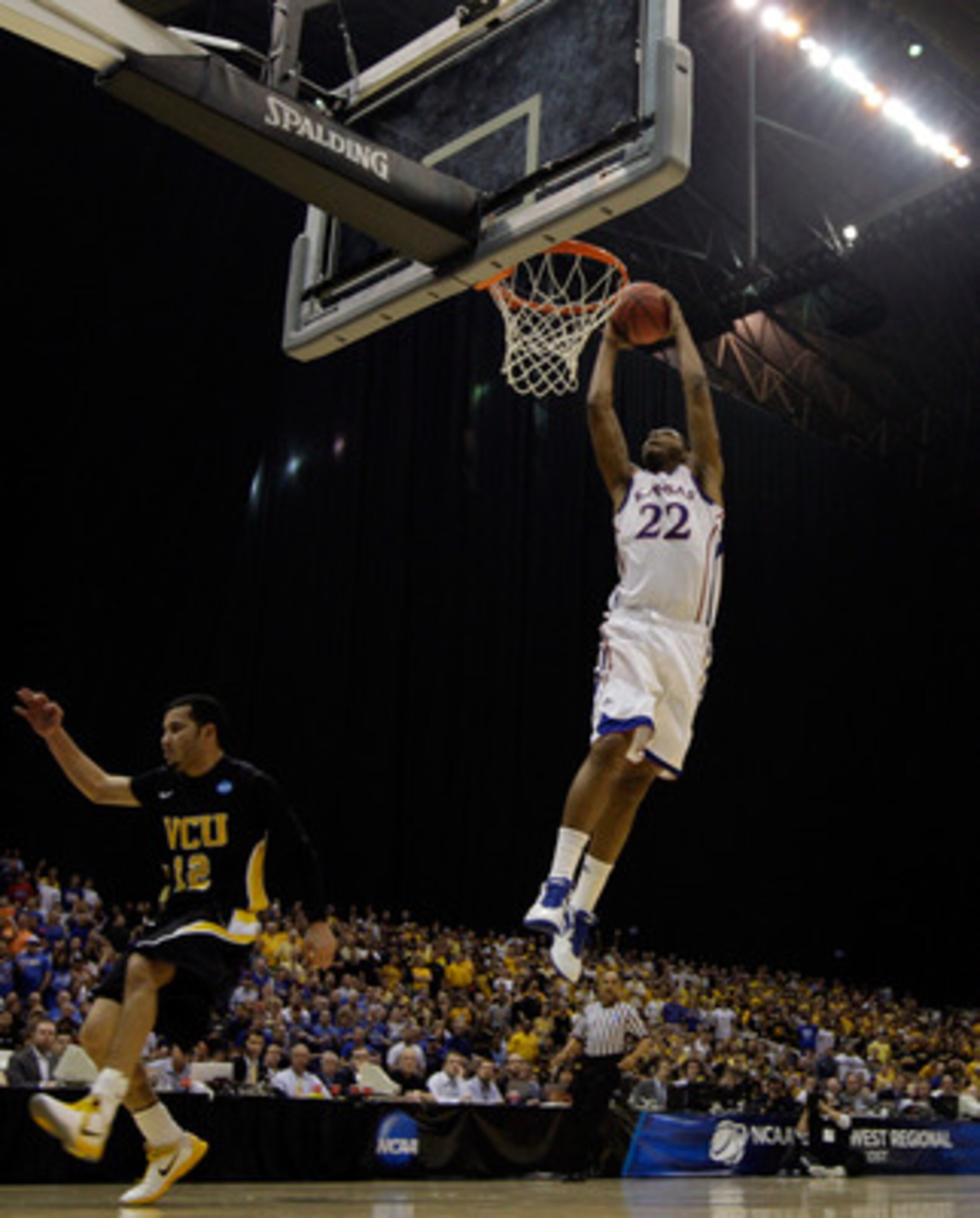 SAN ANTONIO, TX - MARCH 27:  Marcus Morris #22 of the Kansas Jayhawks dunks against Joey Rodriguez #12 of the Virginia Commonwealth Rams during the southwest regional final of the 2011 NCAA men's basketball tournament at the Alamodome on March 27, 2011 in