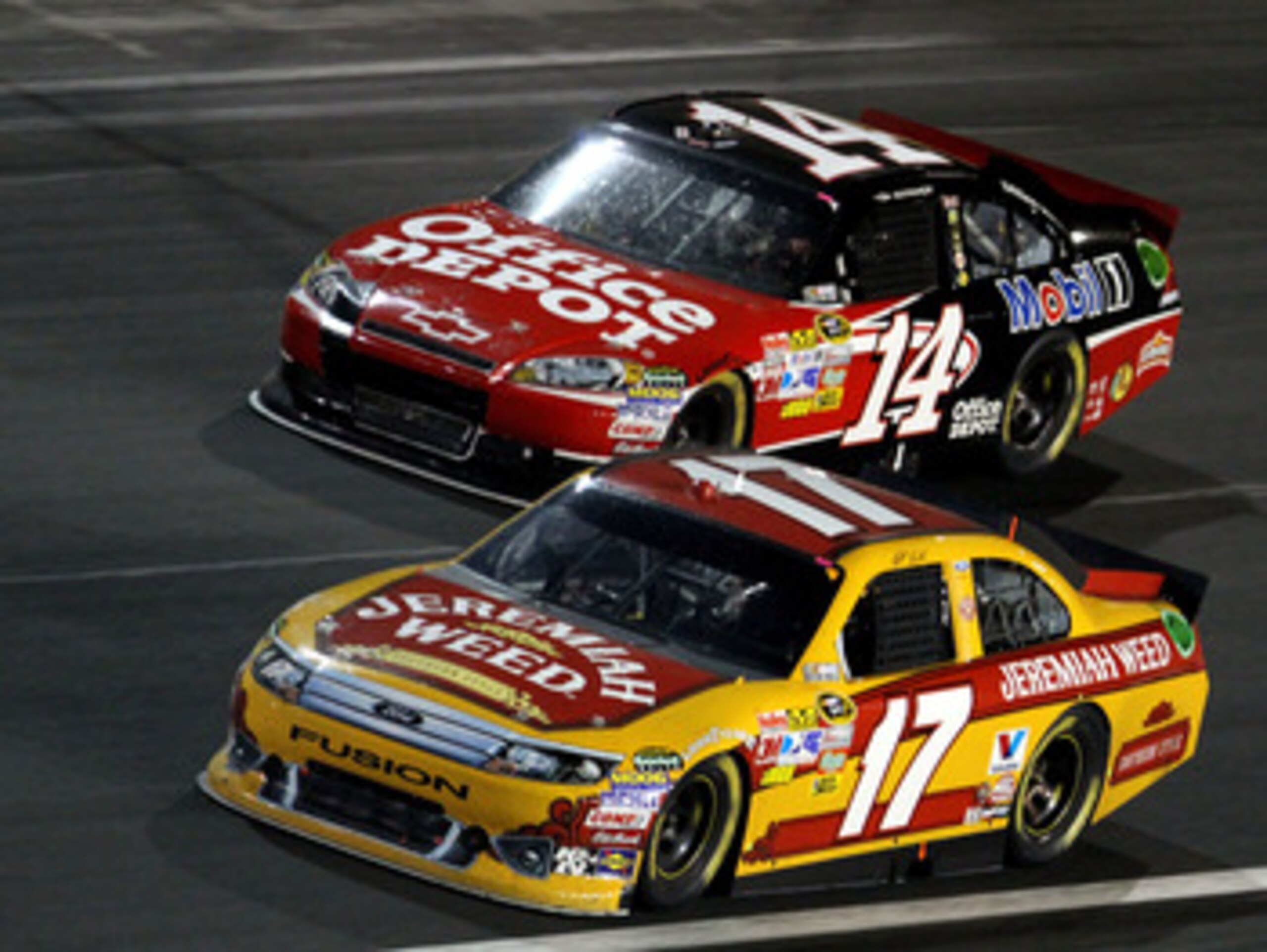 CONCORD, NC - MAY 29: Matt Kenseth, driver of the #17 Jeremiah Weed Ford races with Tony Stewart, driver of the #14 Office Depot / Mobil 1 Chevrolet during the NASCAR Sprint Cup Series Coca-Cola 600 at Charlotte Motor Speedway on May 29, 2011 in Concord, 