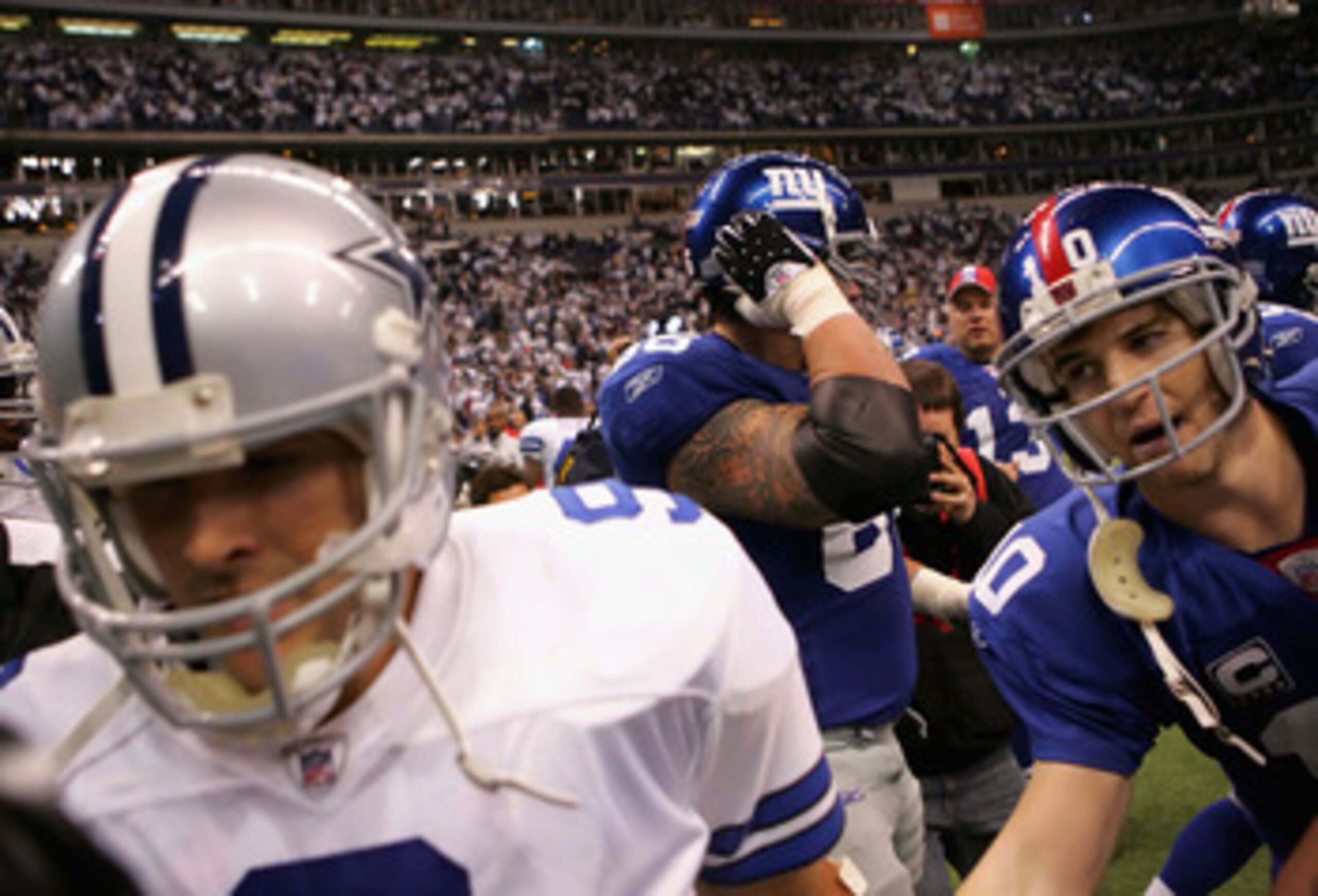IRVING, TX - JANUARY 13:  Quarterback Eli Manning #10 of the New York Giants greets Tony Romo #9 of the Dallas Cowboys after the NFC Divisional Playoff game at Texas Stadium on January 13, 2008 in Irving, Texas. The Giants defeated the Cowboys 21-17.  (Ph