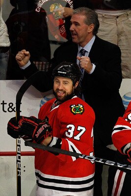 CHICAGO - MAY 23:  Adam Burish #37 and assistant coach Mike Haviland of the Chicago Blackhawks celebrate a late third period goal against the San Jose Sharks as the Blackhawks advance to the Stanley Cup after winning Game Four of the Western Conference Fi