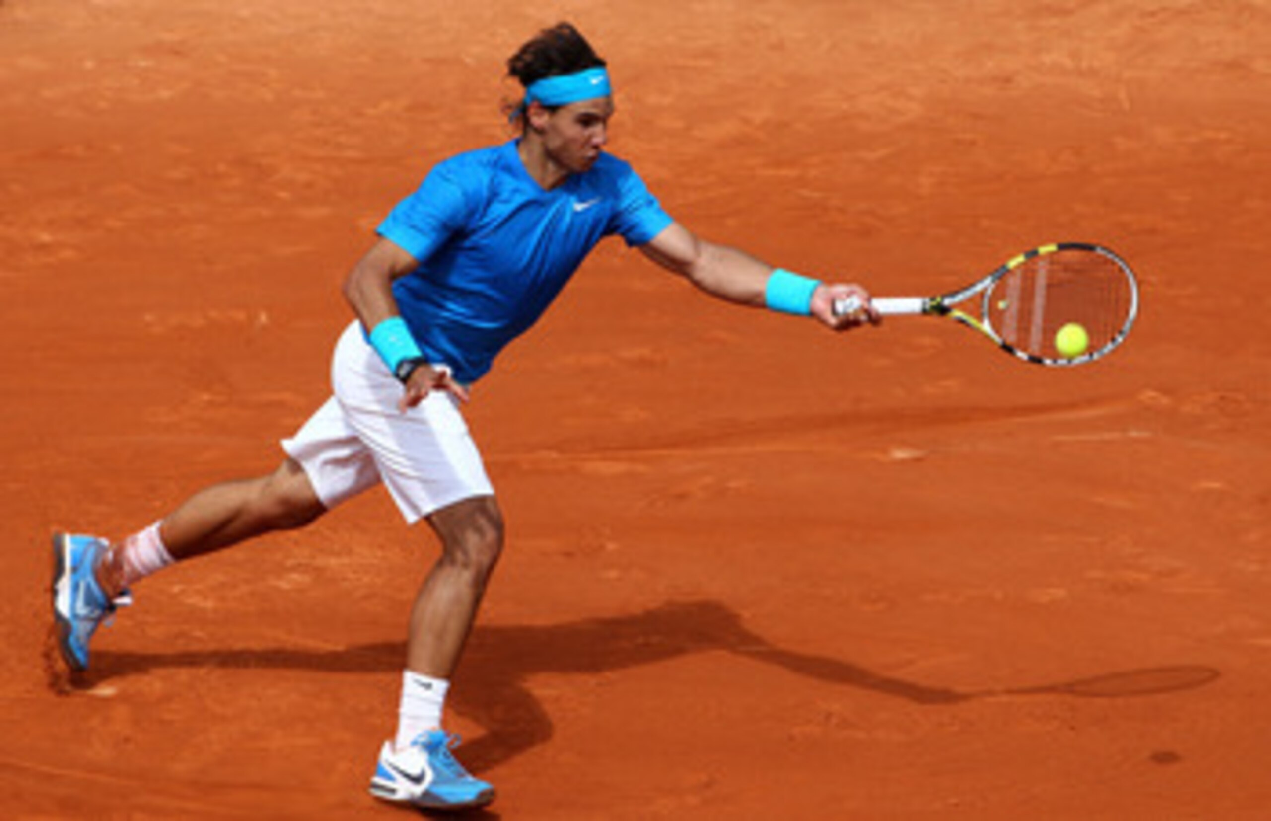 PARIS, FRANCE - MAY 30:  Rafael Nadal of Spain plays a forehand during the men's singles round four match between Rafael Nadal of Spain and Ivan Lubicic of Croatia on day nine of the French Open at Roland Garros on May 30, 2011 in Paris, France.  (Photo b