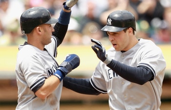 OAKLAND, CA - MAY 30:  Mark Teixeira #25 of the New York Yankees is congratulated by Derek Jeter #2 of the New York Yankees after Teixeira hit a home run to score them both in the first inning against the Oakland Athletics at Oakland-Alameda County Colise