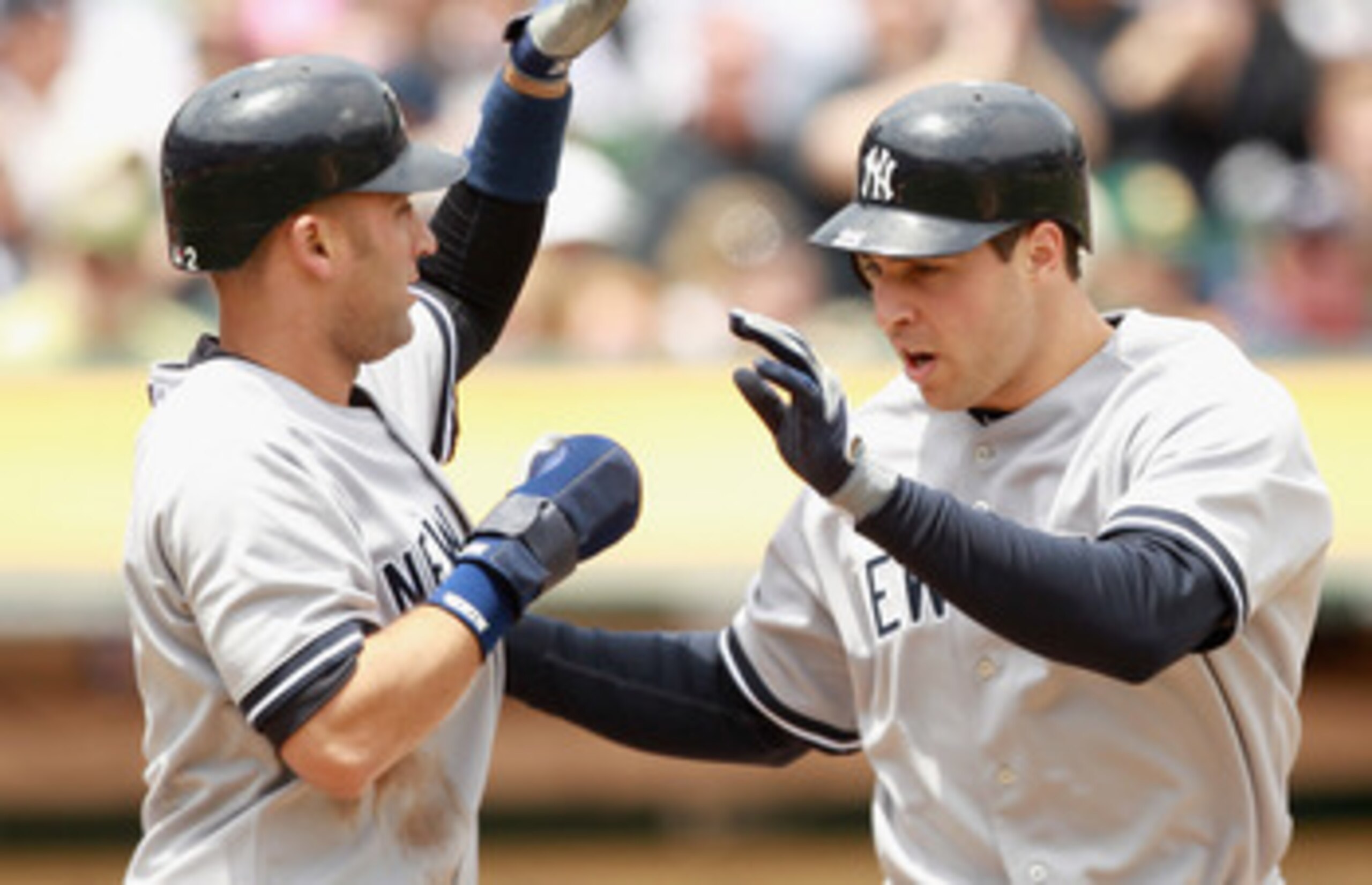 OAKLAND, CA - MAY 30:  Mark Teixeira #25 of the New York Yankees is congratulated by Derek Jeter #2 of the New York Yankees after Teixeira hit a home run to score them both in the first inning against the Oakland Athletics at Oakland-Alameda County Colise