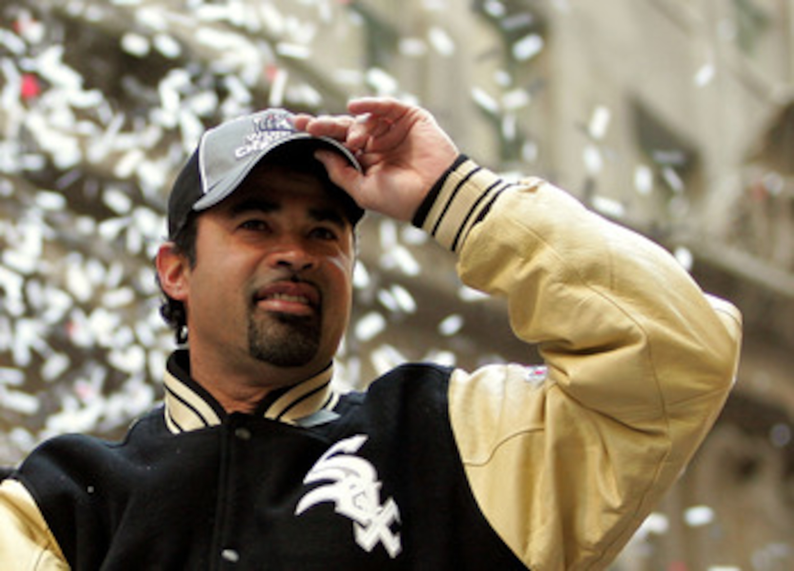 CHICAGO - OCTOBER 28:  Chicago White Sox manager Ozzie Guillen reaches for his hat as he waves to fans from a double-decker bus during a ticker-tape parade for the White Sox baseball team October 28, 2005 in downtown Chicago, Illinois. The Chicago White S