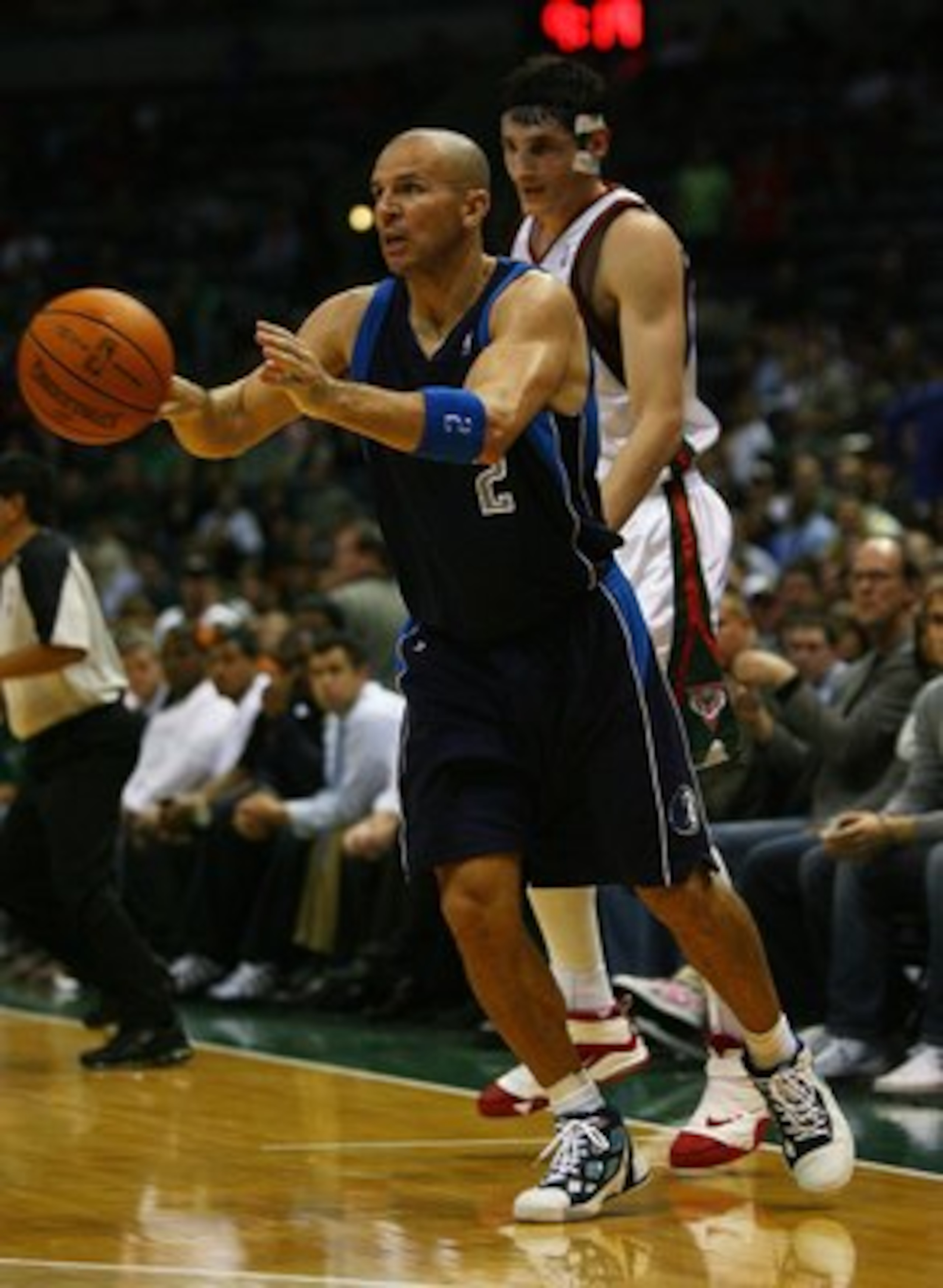 MILWAUKEE - NOVEMBER 16: Jason Kidd #2 of the Dallas Mavericks passes the ball as Ersan Ilyasova #7 of the Milwaukee Bucks defends at the Bradley Center on November 16, 2009 in Milwaukee, Wisconsin. The Mavericks defeated the Bucks 115-113 in overtime.  (