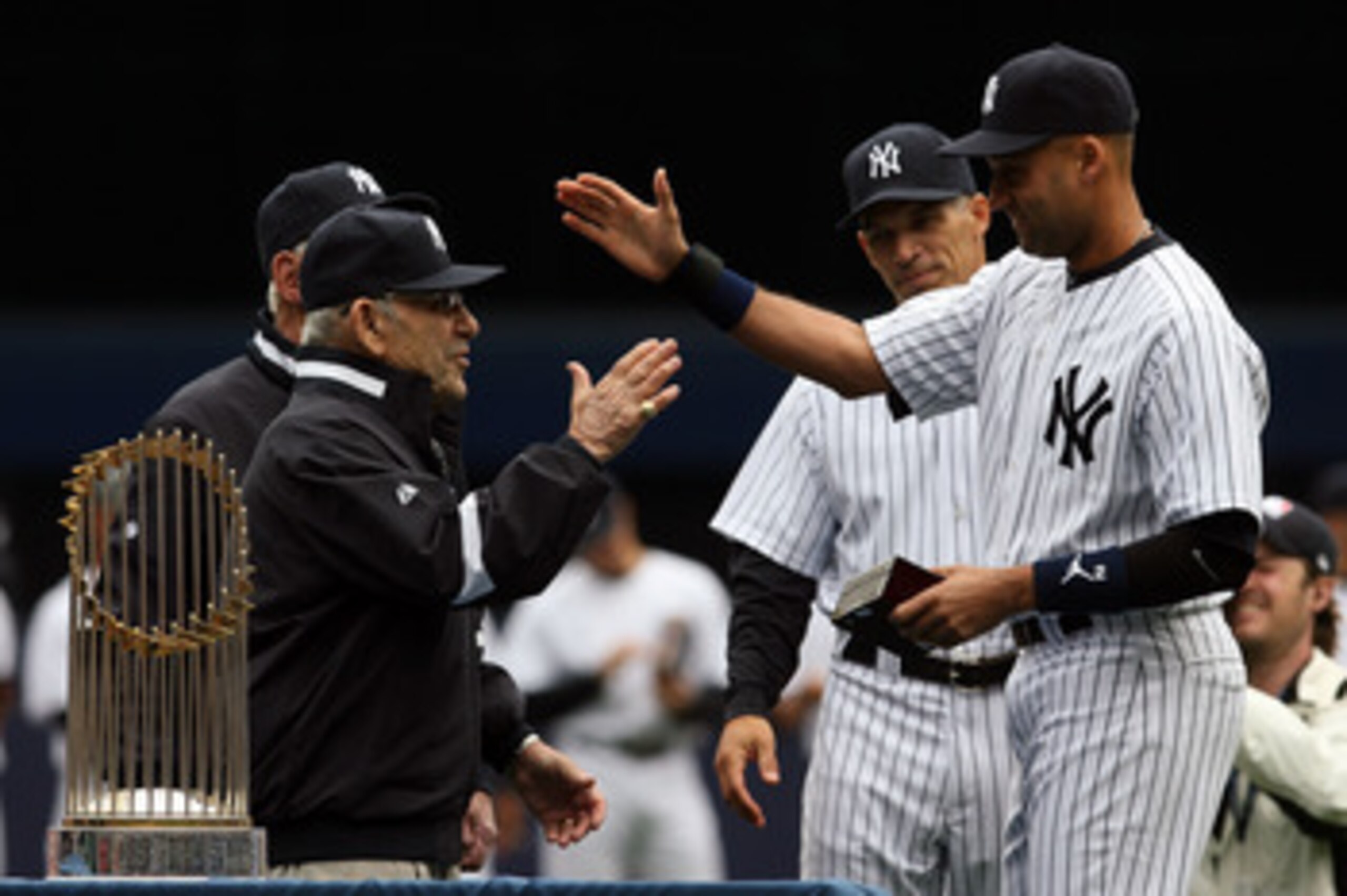 NEW YORK - APRIL 13:  Yankee legend and Baseball Hall of Famer Yogi Berra presents Derek Jeter #2 of the New York Yankees with his World Series ring for the 2009 season prior to playing against the Los Angeles Angels of Anaheim during the Yankees home ope