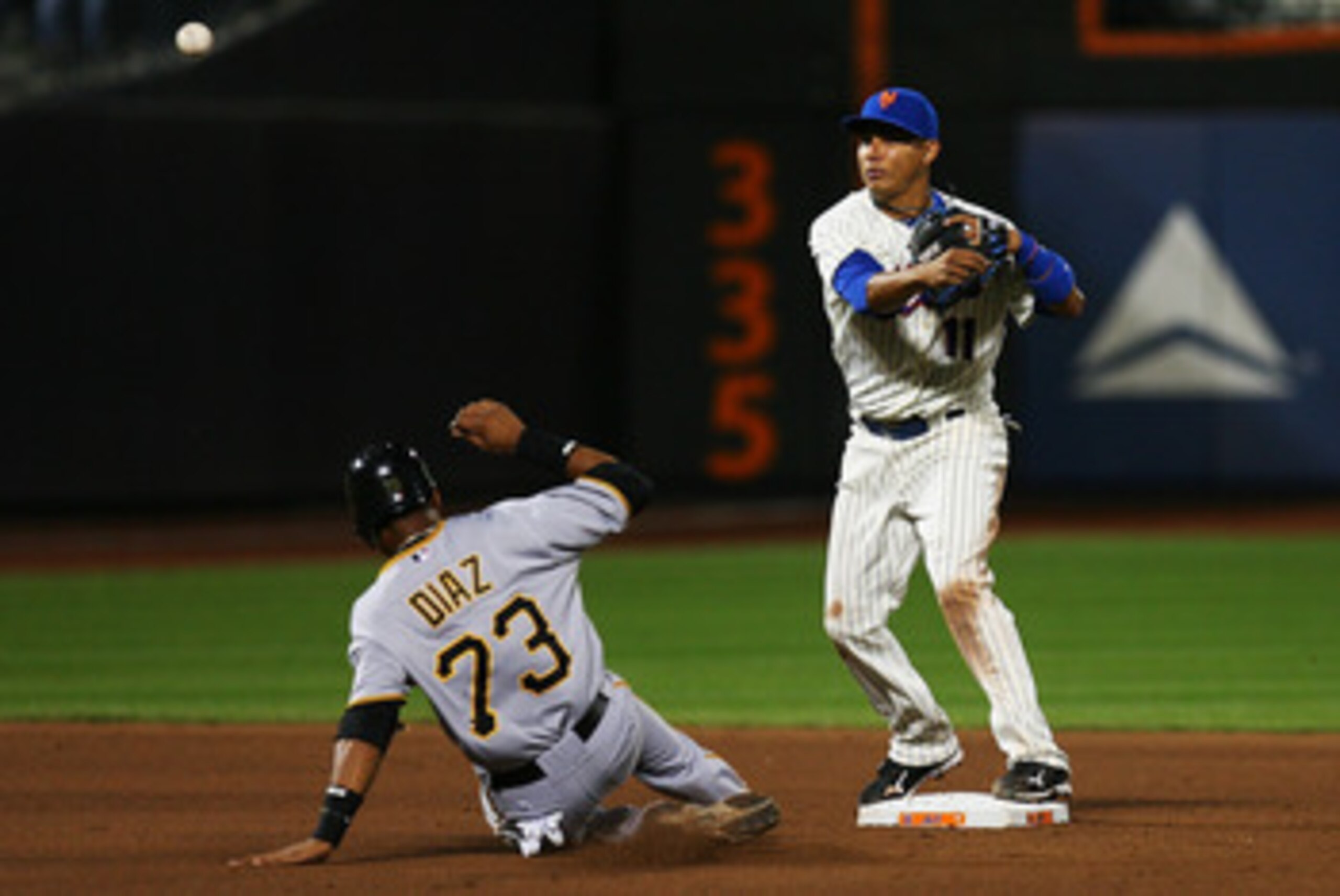 NEW YORK - SEPTEMBER 14:  Ruben Tejada #11 of the New York Mets completes a double play while Argenis Diaz #73 of the Pittsburgh Pirates unsuccessfully slides into second base in the eighth inning on September 14, 2010 at Citi Field in the Flushing neighb