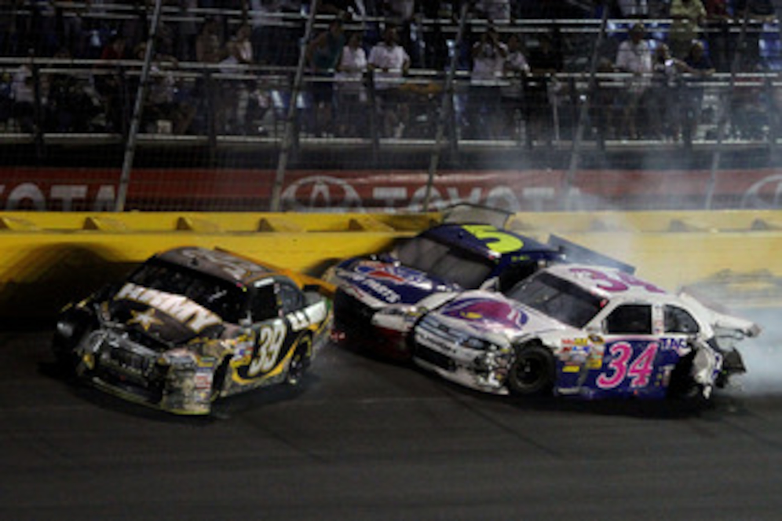 CONCORD, NC - MAY 29:  Ryan Newman, driver of the #39 U.S. Army Chevrolet, David Gilliland, driver of the #34 Taco Bell Ford, and Mark Martin, driver of the #5 Carquest/GoDaddy.com Chevrolet, hit the wall after an incidnet in the NASCAR Sprint Cup Series 