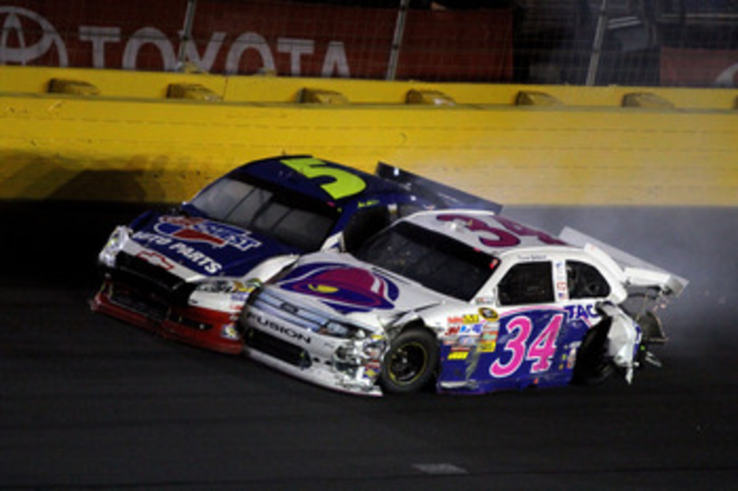CONCORD, NC - MAY 29:  David Gilliland, driver of the #34 Taco Bell Ford, and Mark Martin, driver of the #5 Carquest/GoDaddy.com Chevrolet, collide after hitting the wall during the NASCAR Sprint Cup Series Coca-Cola 600 at Charlotte Motor Speedway on May